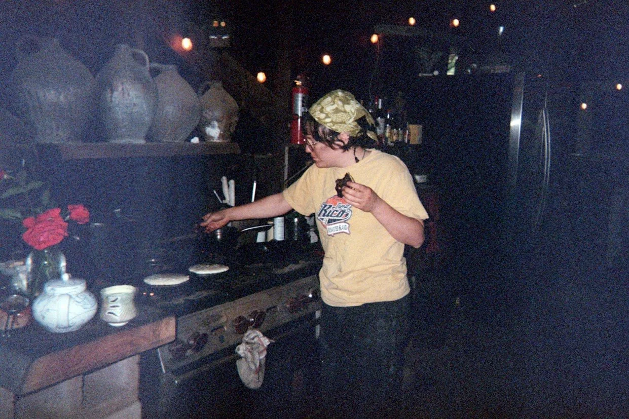 Summer making pancakes in the morning. Disposable camera photo by Jules.