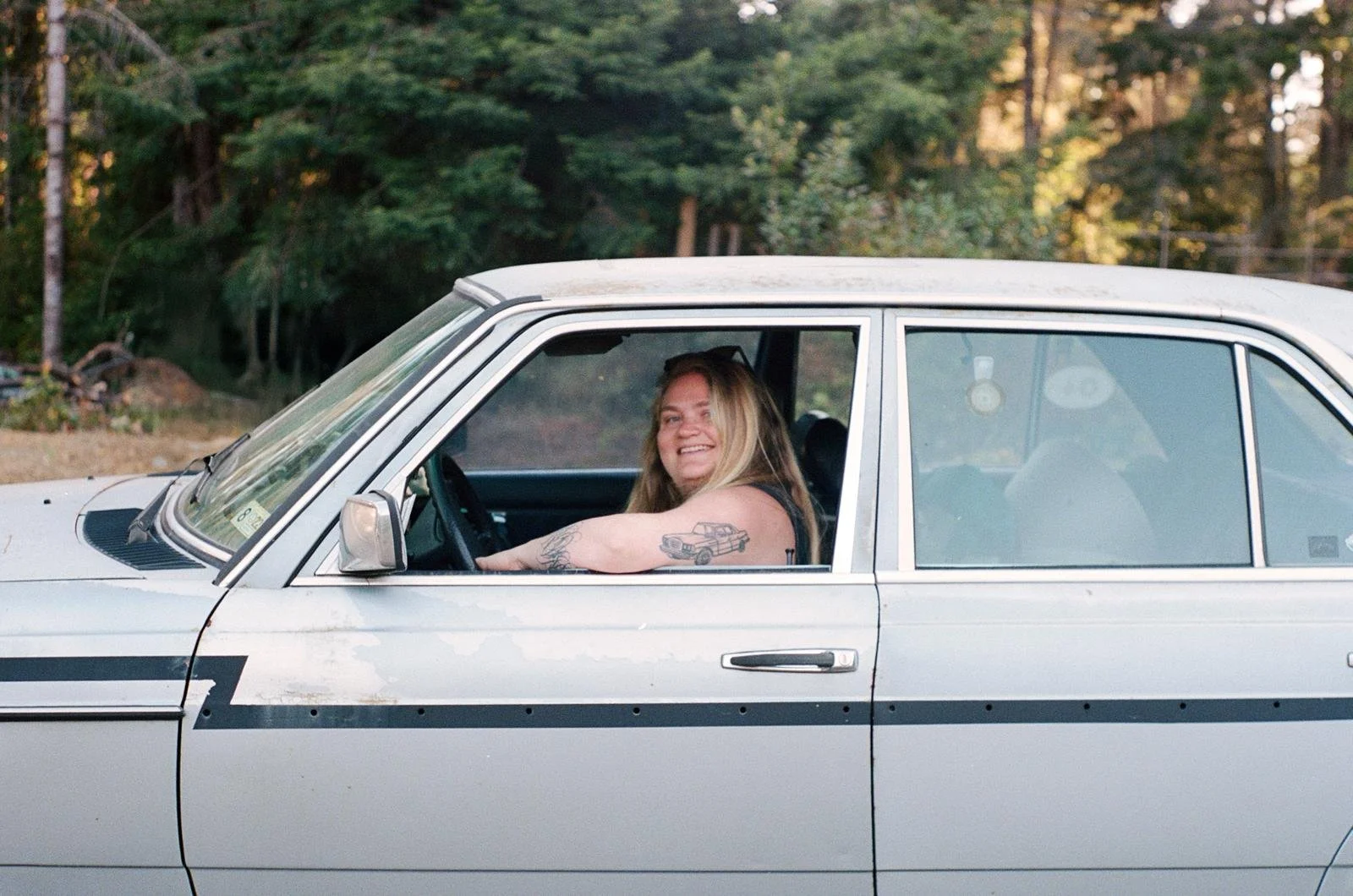legend Katie Applebaum in their legend car with legend car tattoo. Photo by Katie Goode Donaldson