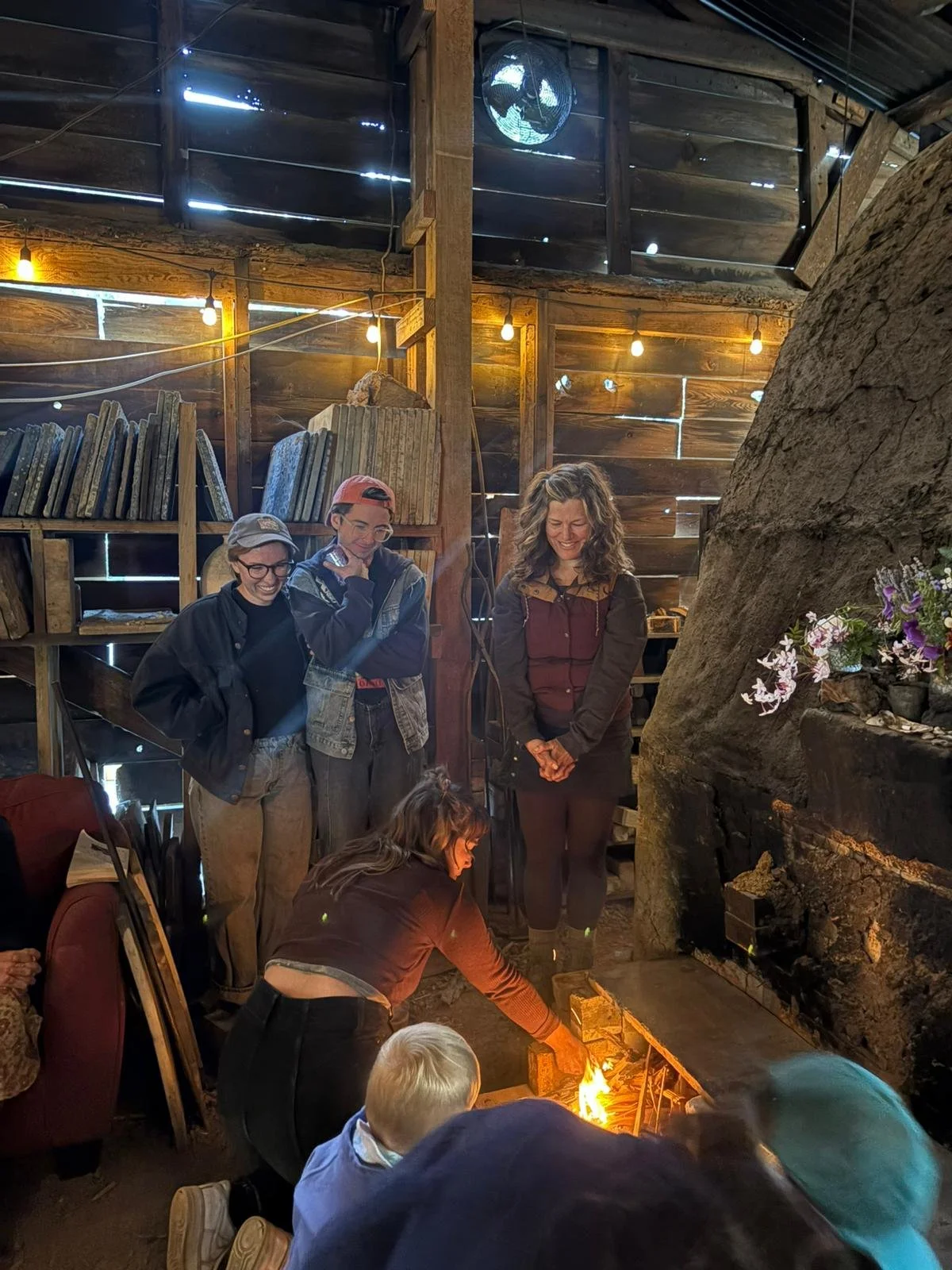 Lighting ceremony. Jules, Dan, and Jess in the background. Azelia, Rocco, and Lexi lighting the kiln since it's their first firing.