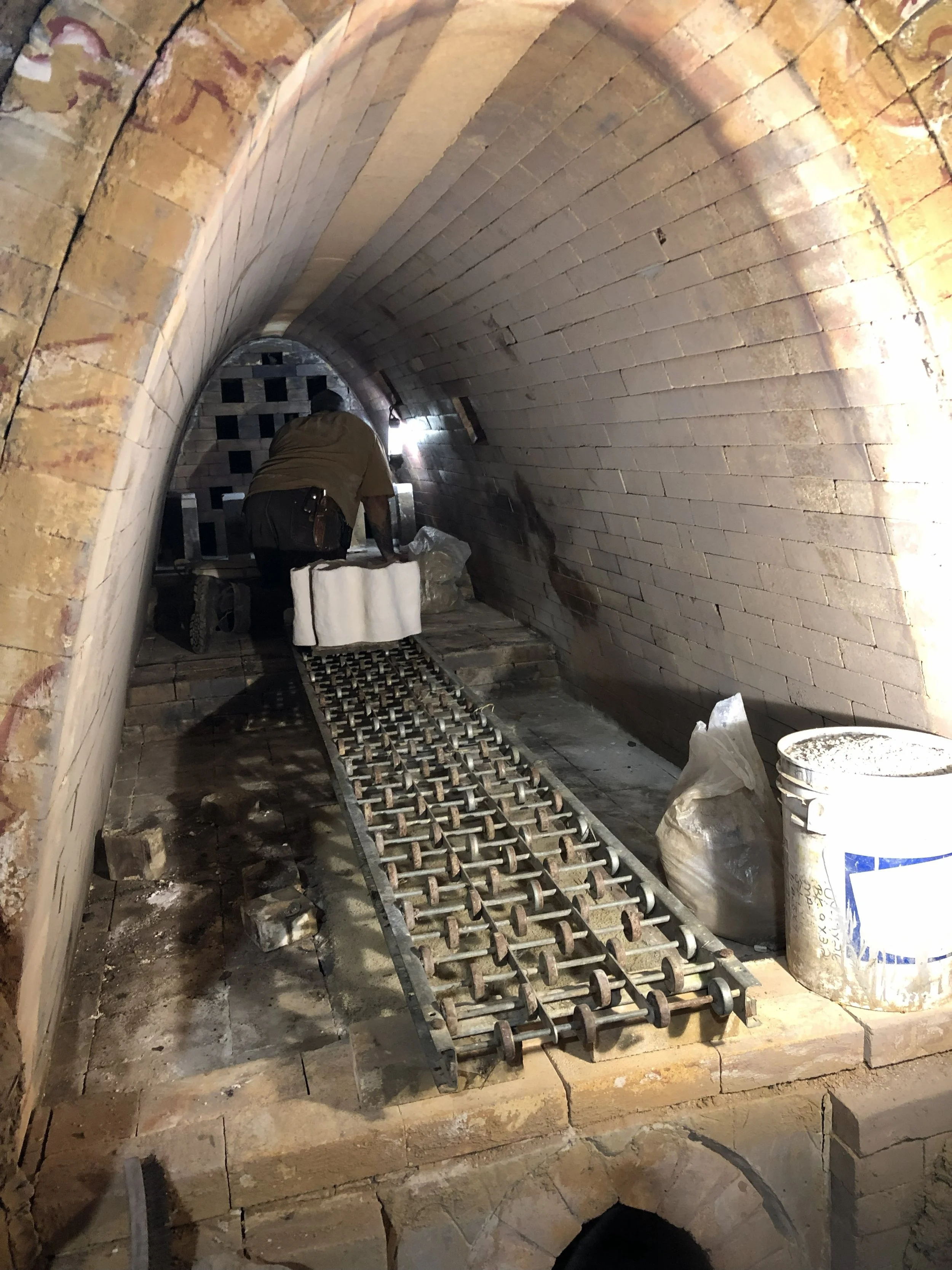 rolling pieces to the back of the kiln