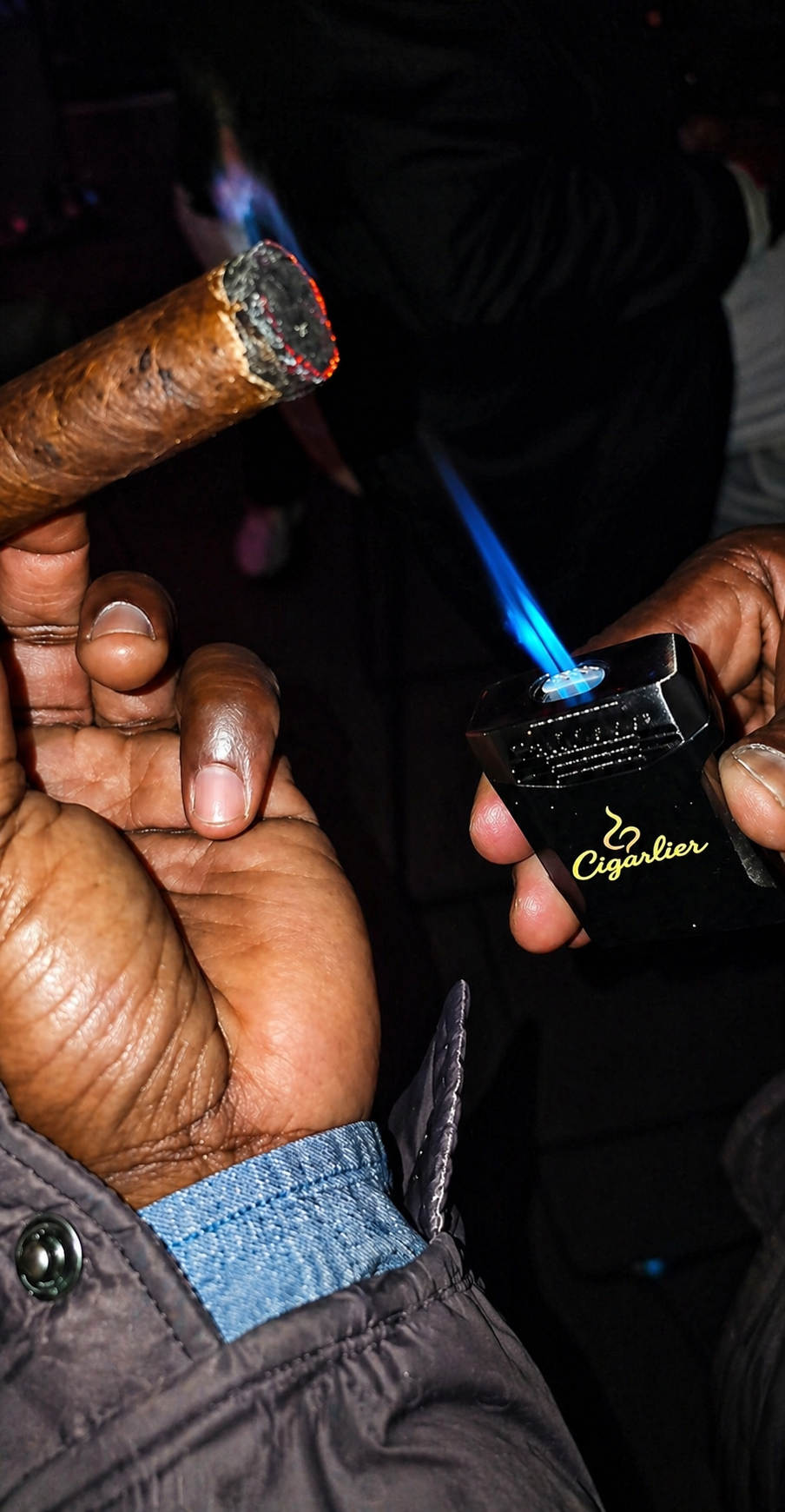 A cigar being lit with the Cigarlier dual-flame torch