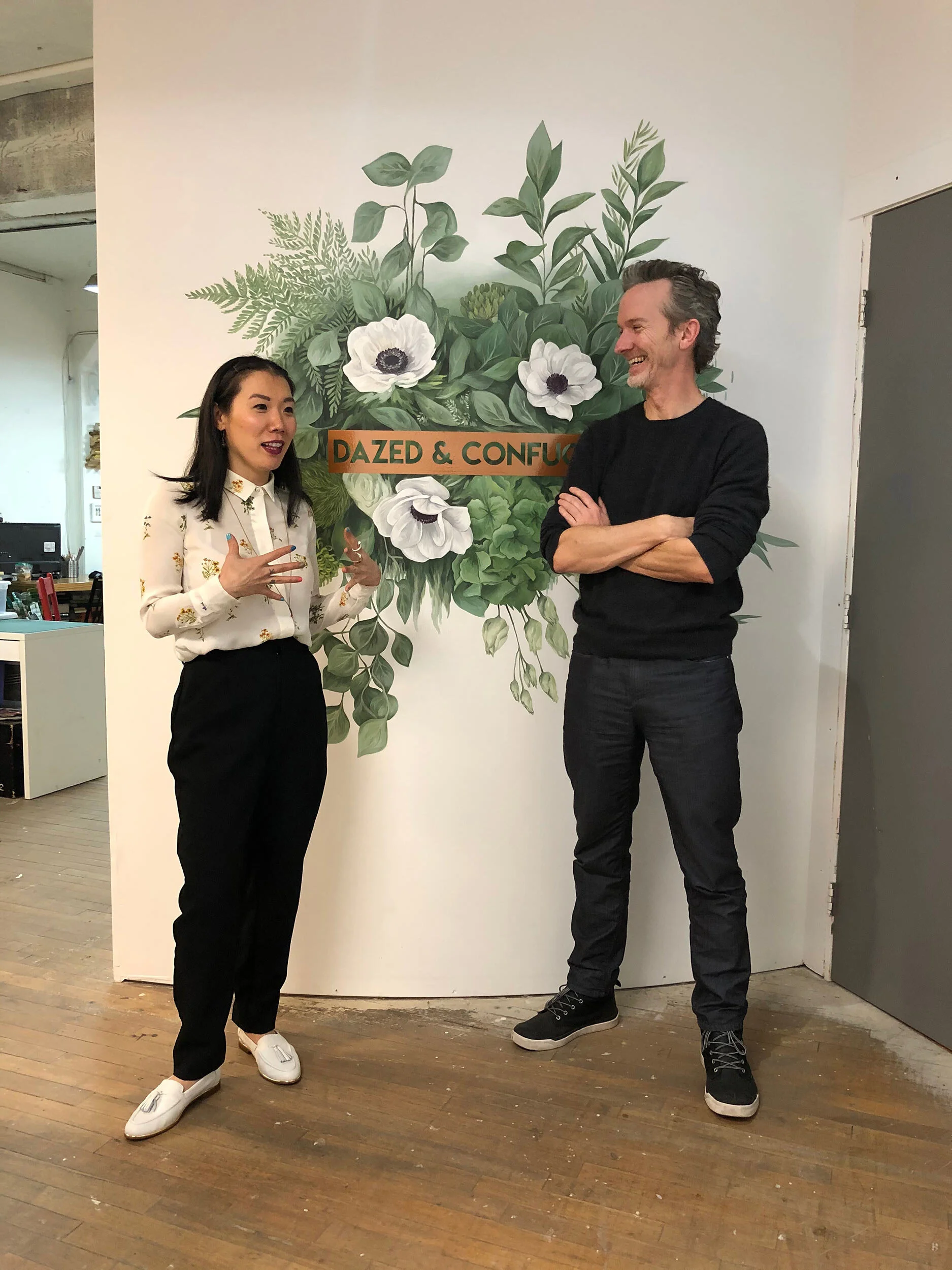 Pennylane and David at Pennylane’s Vancouver office at Parker Street Studios. Mural by Dazed &amp; Confucius client, Jennifer Clark.