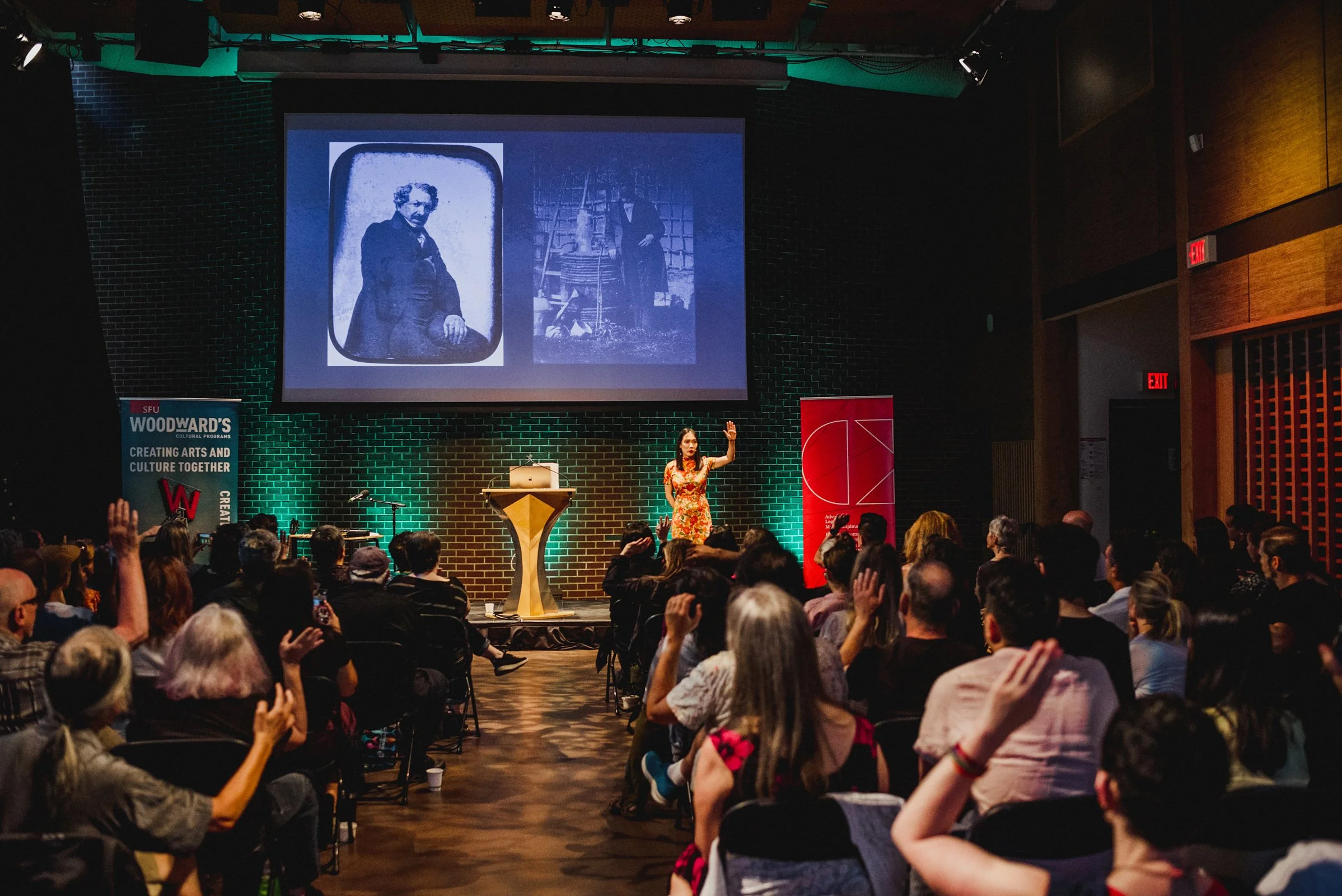 Pennylane Shen at Creative Mornings Vancouver, in the SFU Woodwards Building. The audience is seated and some people are raising their hands.