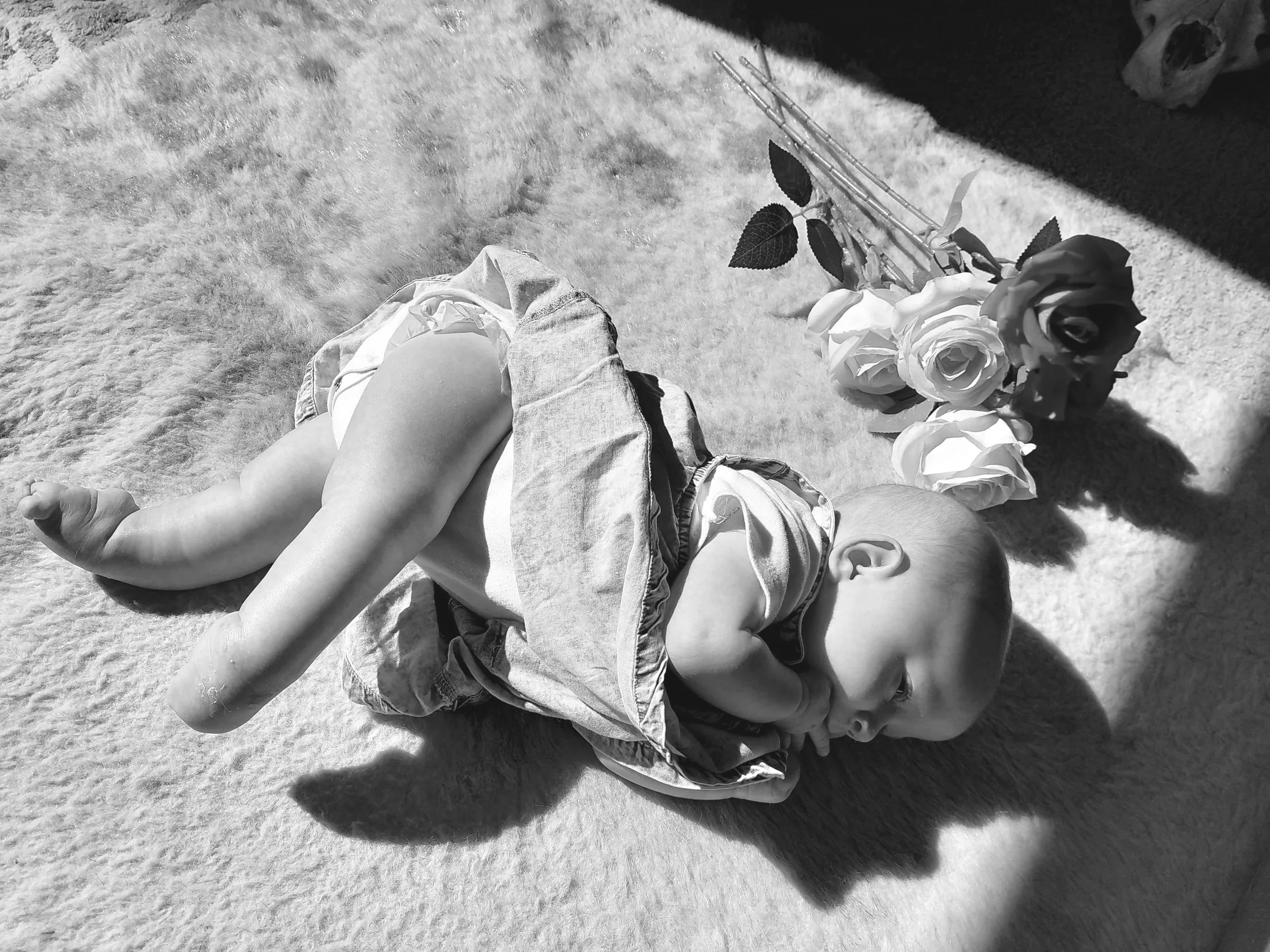 Hannah-rose stretching out her hyper extended legs joint differences AMC awareness,wearing denim, laying on a sheepskin rug