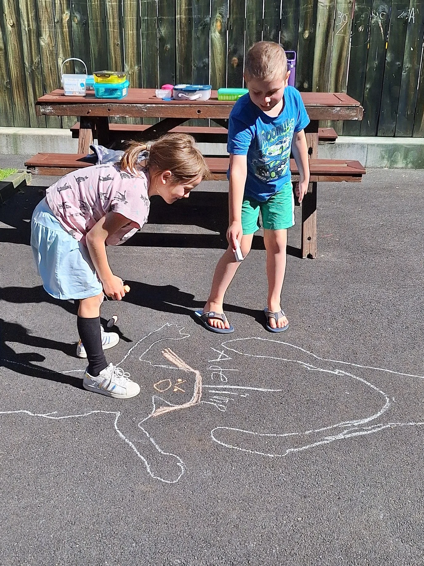 Julian Dean giving a presentation in a bright, modern room with large windows, audience seated facing him.