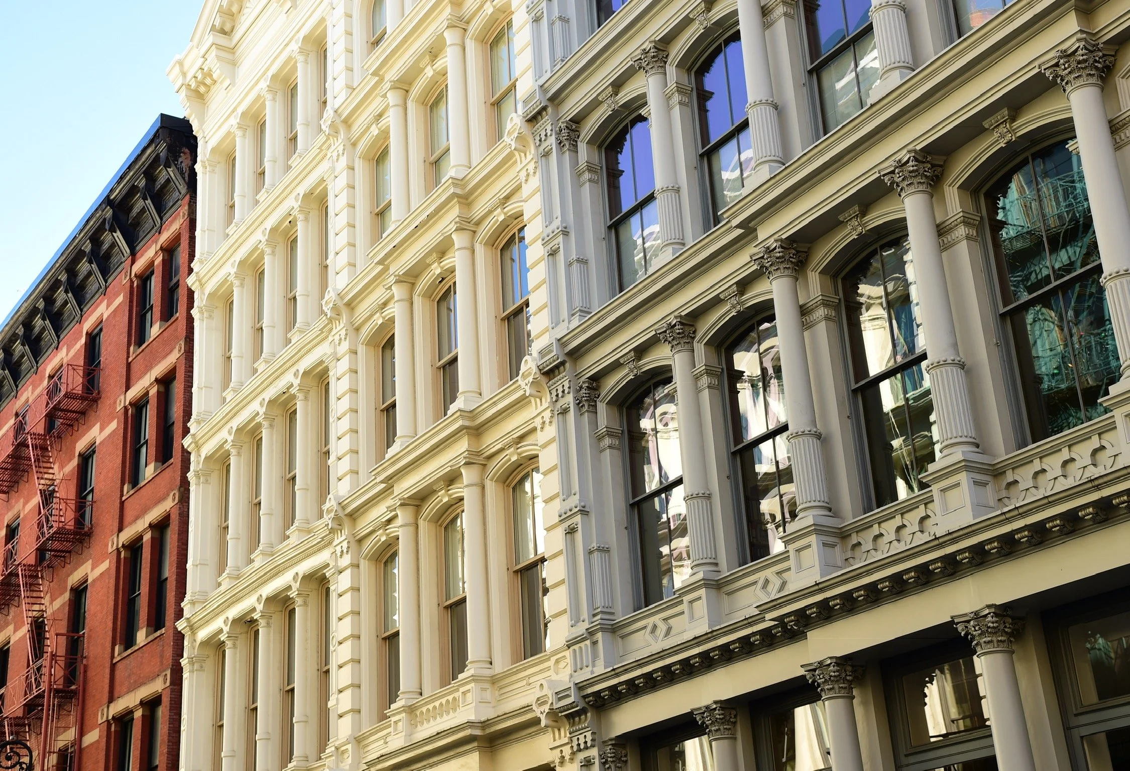 Street-level view of historic SoHo building façades in New York City, illustrating architectural conditions relevant to existing building assessments.