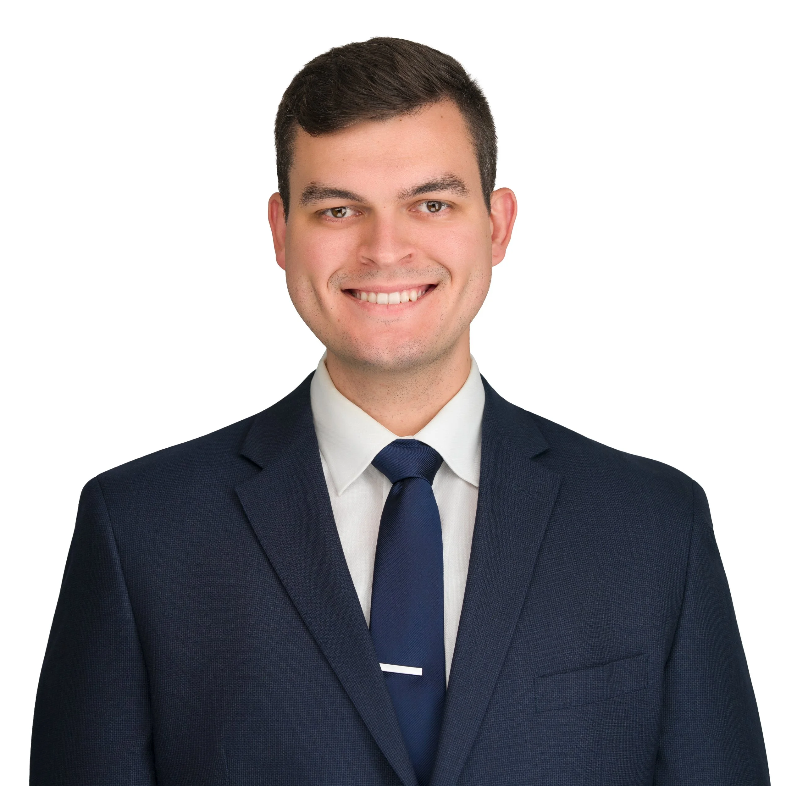 Image of Dylan Angel in a navy suite and navy blue tie.
