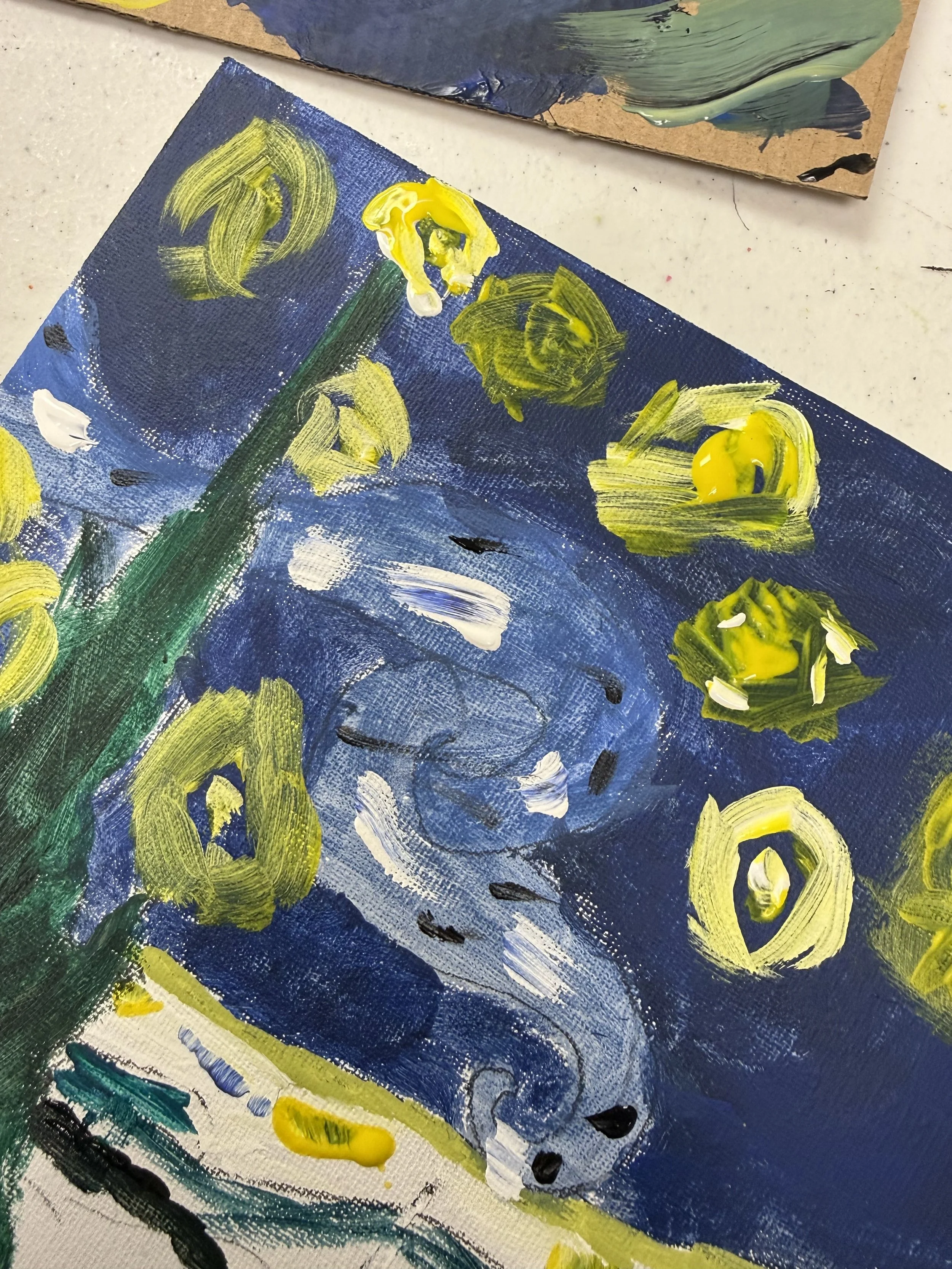 Close-up of an impressionist painting of yellow flowers and swirling blue sky, created with thick brushstrokes of paint on canvas.