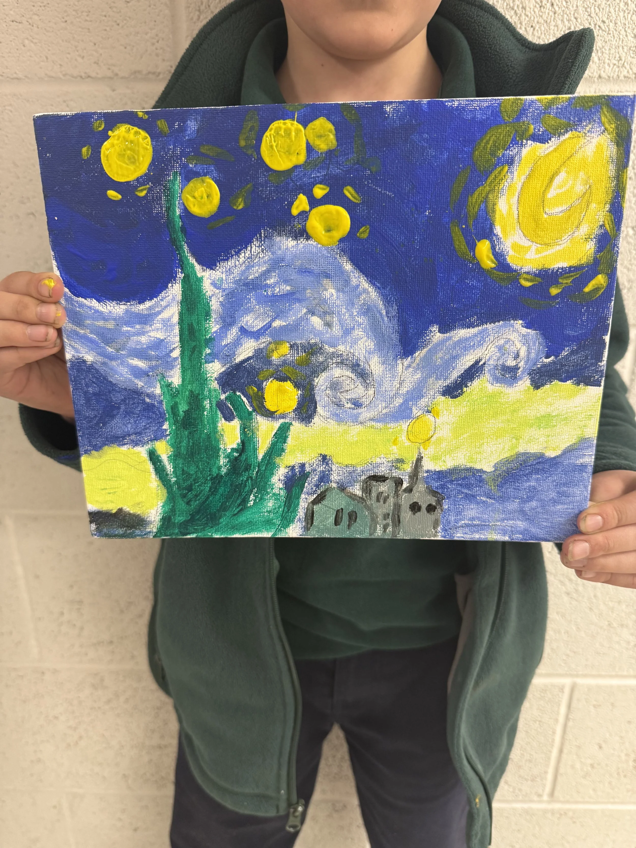 Child holding a painting of a night sky with swirling clouds, a bright yellow sun, and stars, with green shapes and small houses at the bottom.