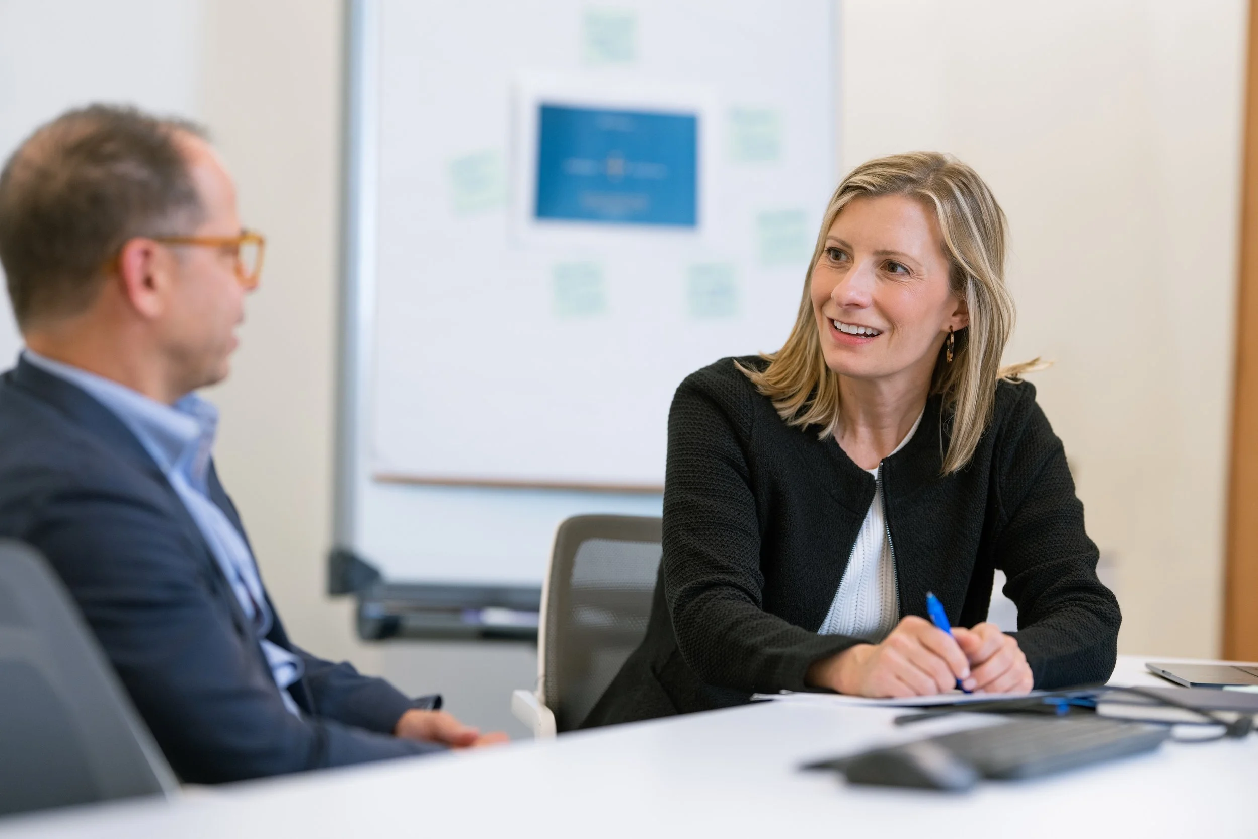 Paige Panda advising a nonprofit leader in a meeting room