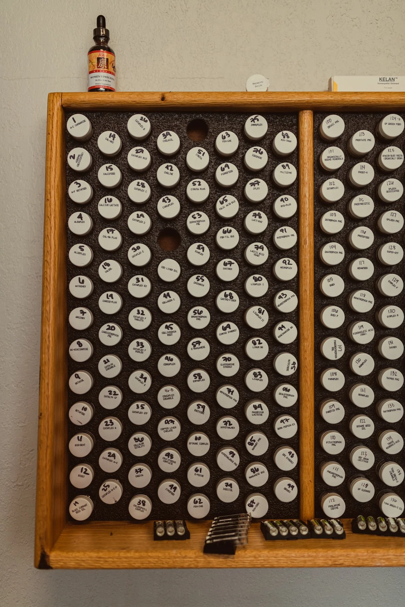 Glass testing vials labeled for Morphogenic Field Technique (MFT) at the Center for Classical Chinese Medicine, used to identify imbalances and guide personalized treatment plans.