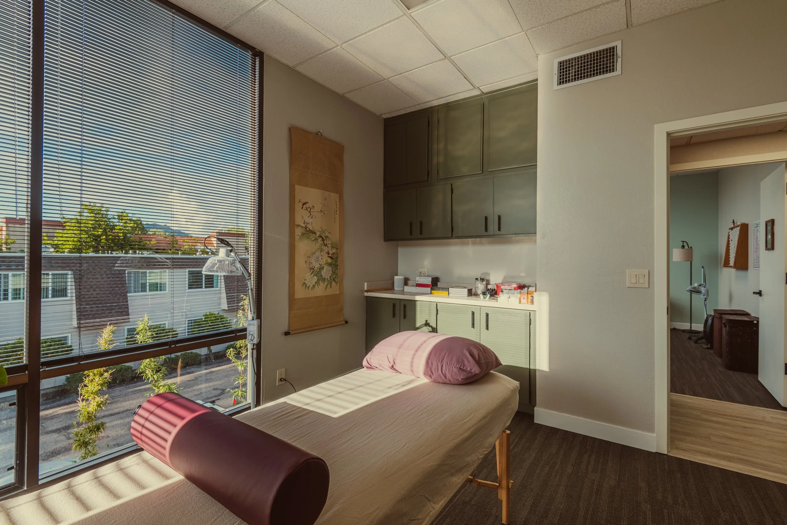 Sunlit acupuncture treatment room at the Center for Classical Chinese Medicine in San Luis Obispo, offering a calm and restorative environment for pain relief.
