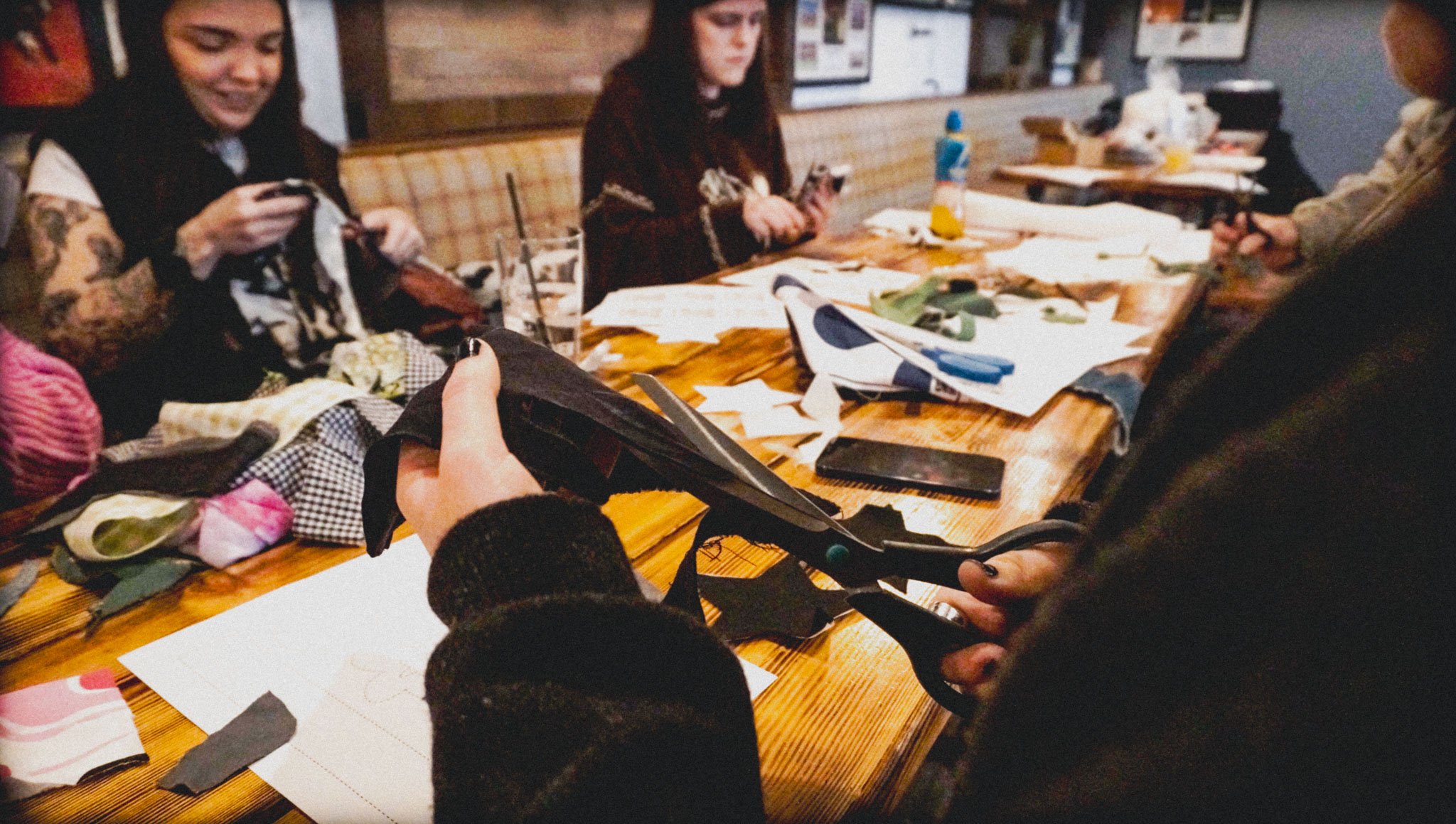 Small group taking part in a hands-on fashion and printmaking workshop in South Wales.