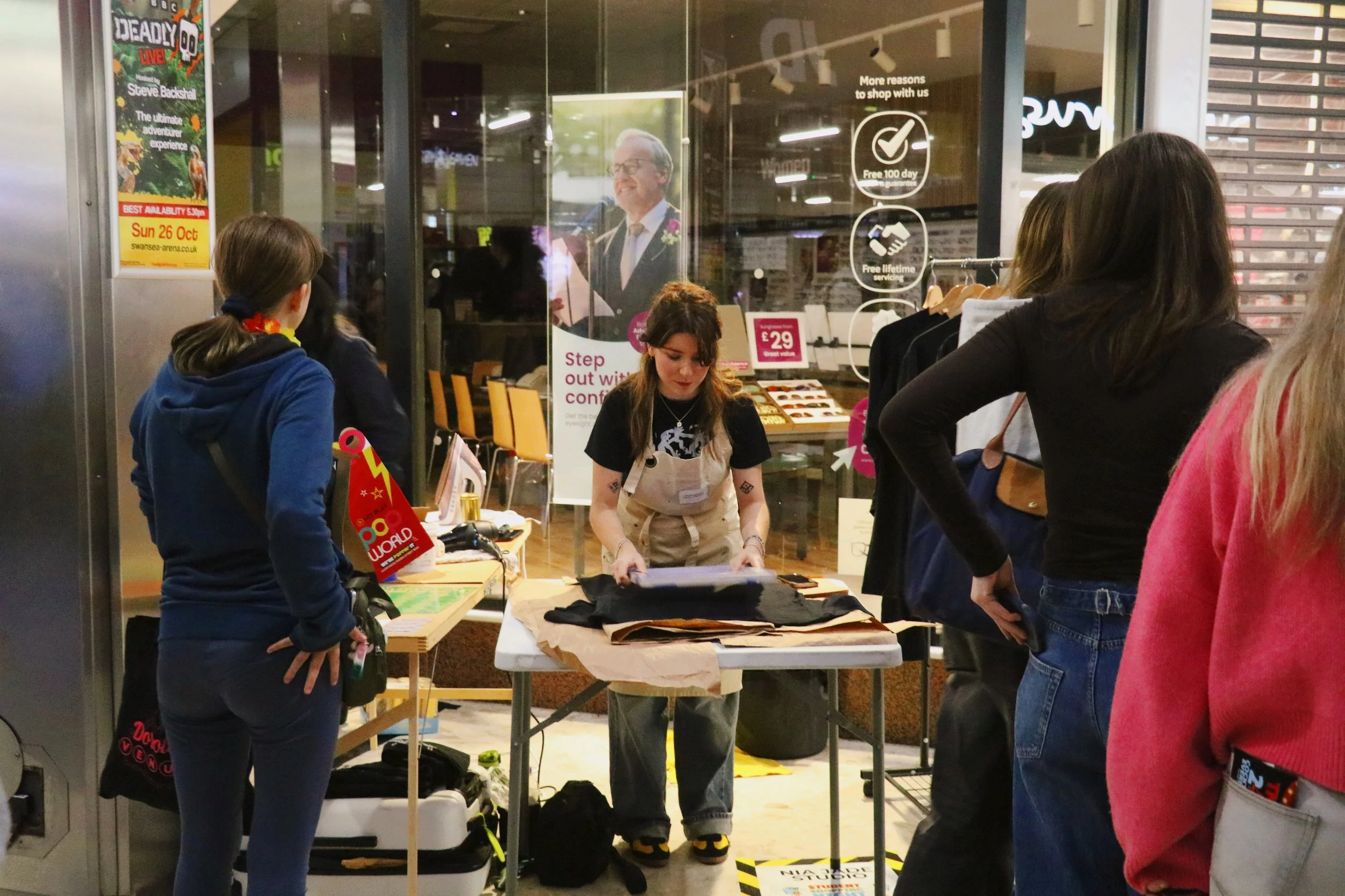Hand screen printing process in a Swansea studio, creating small-batch t-shirts.