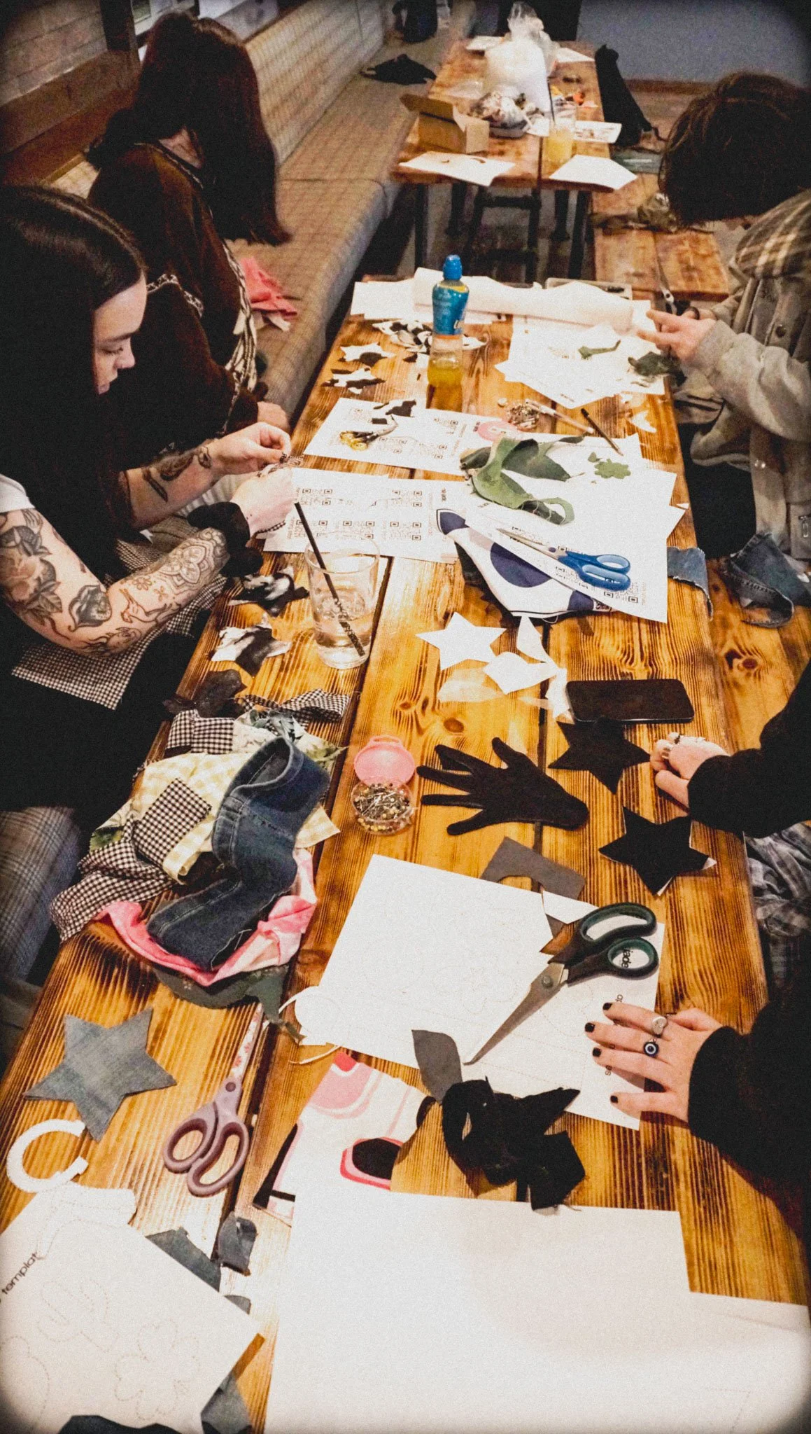 Participants learning sewing techniques during a creative studio workshop.
