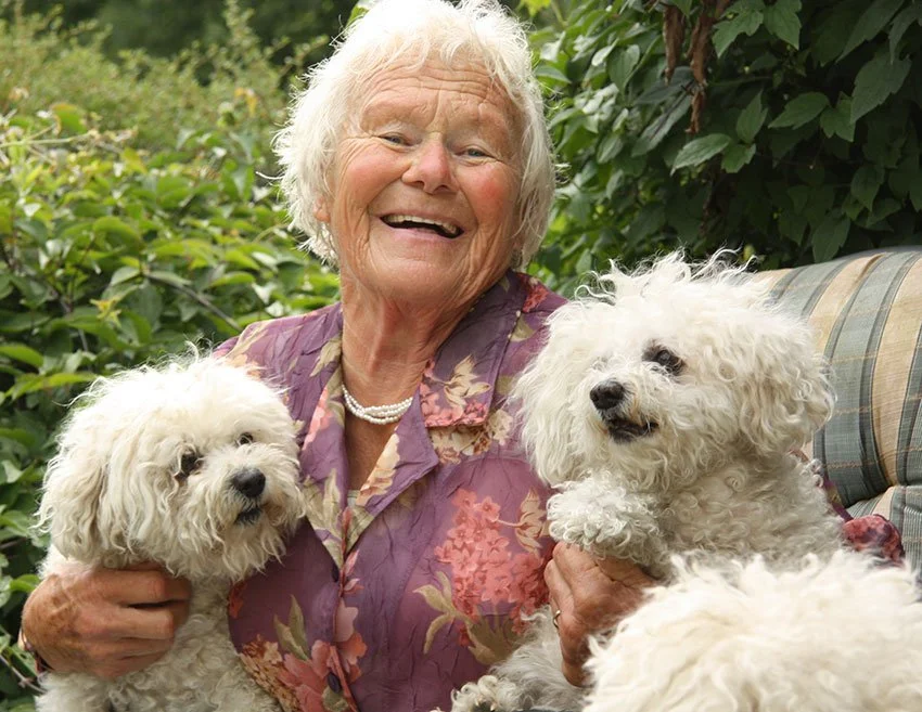 elderly woman with pet dogs