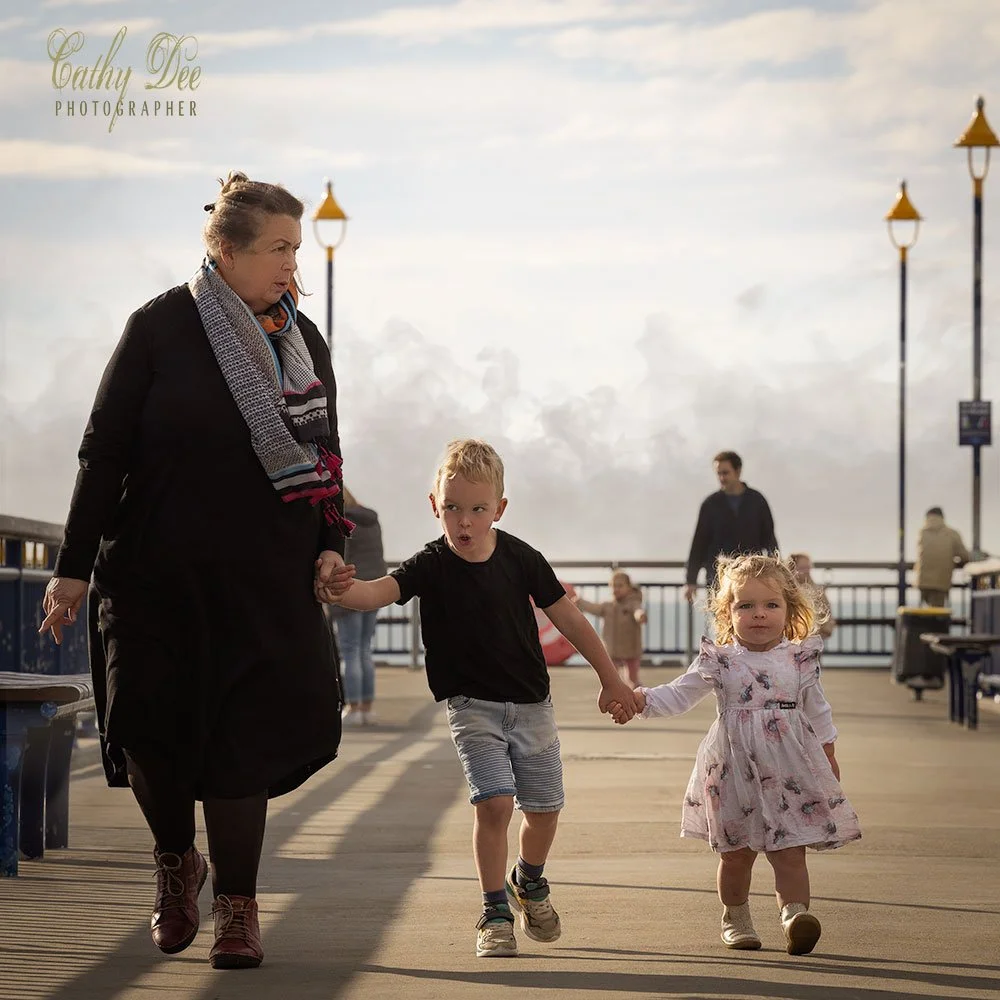 Grandmother walking with small grandkids