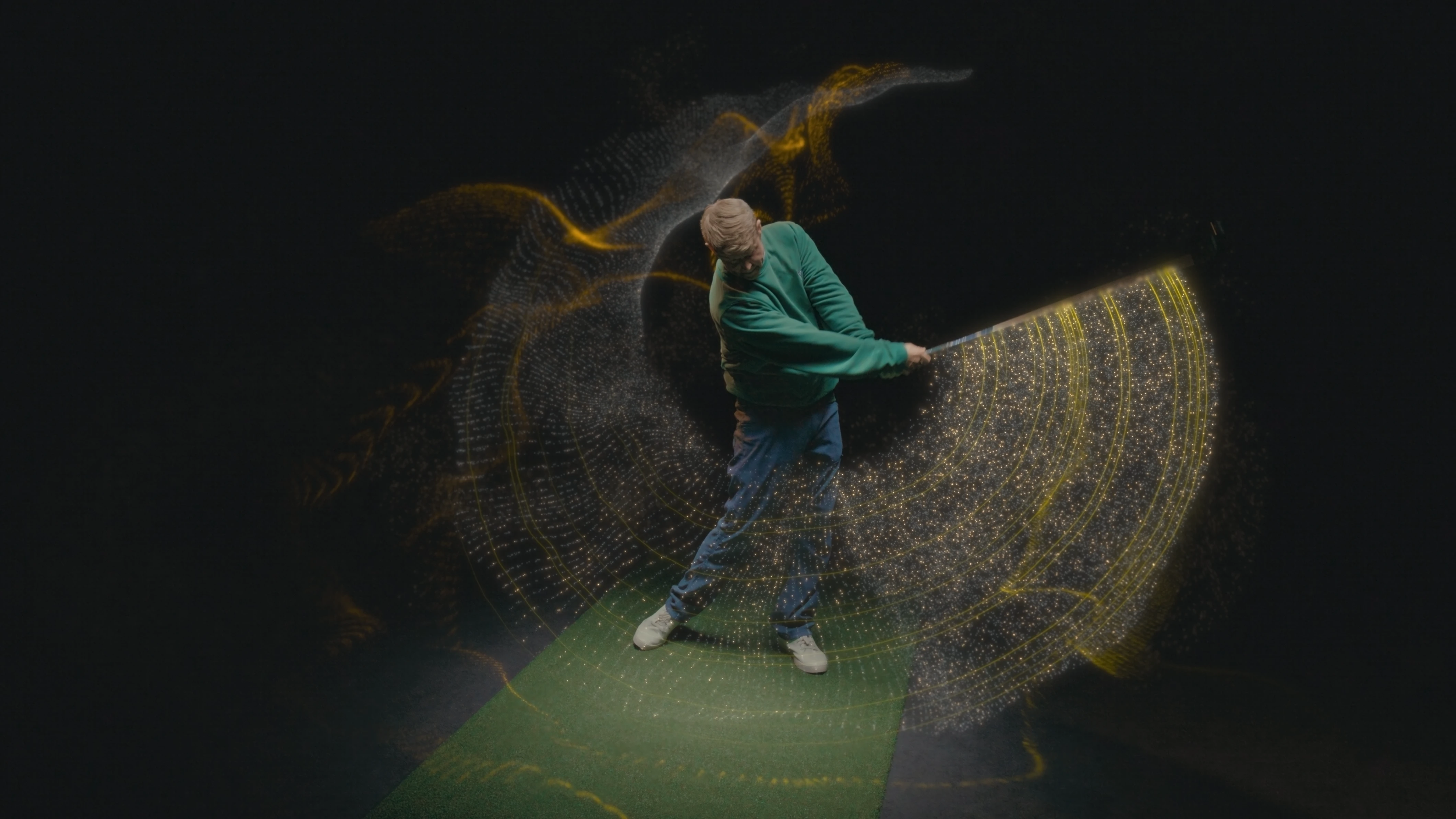 Person standing on a green mat, holding a golf club, surrounded by golden digital light patterns and particles, creating a dynamic motion effect.