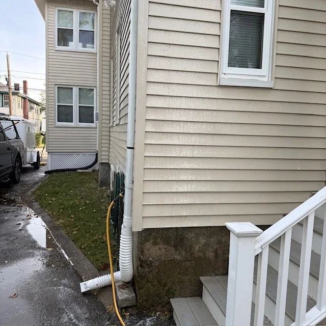 After: Vinyl siding after professional soft washing in Quincy, MA — dirt and stains removed for a bright, refreshed exterior.