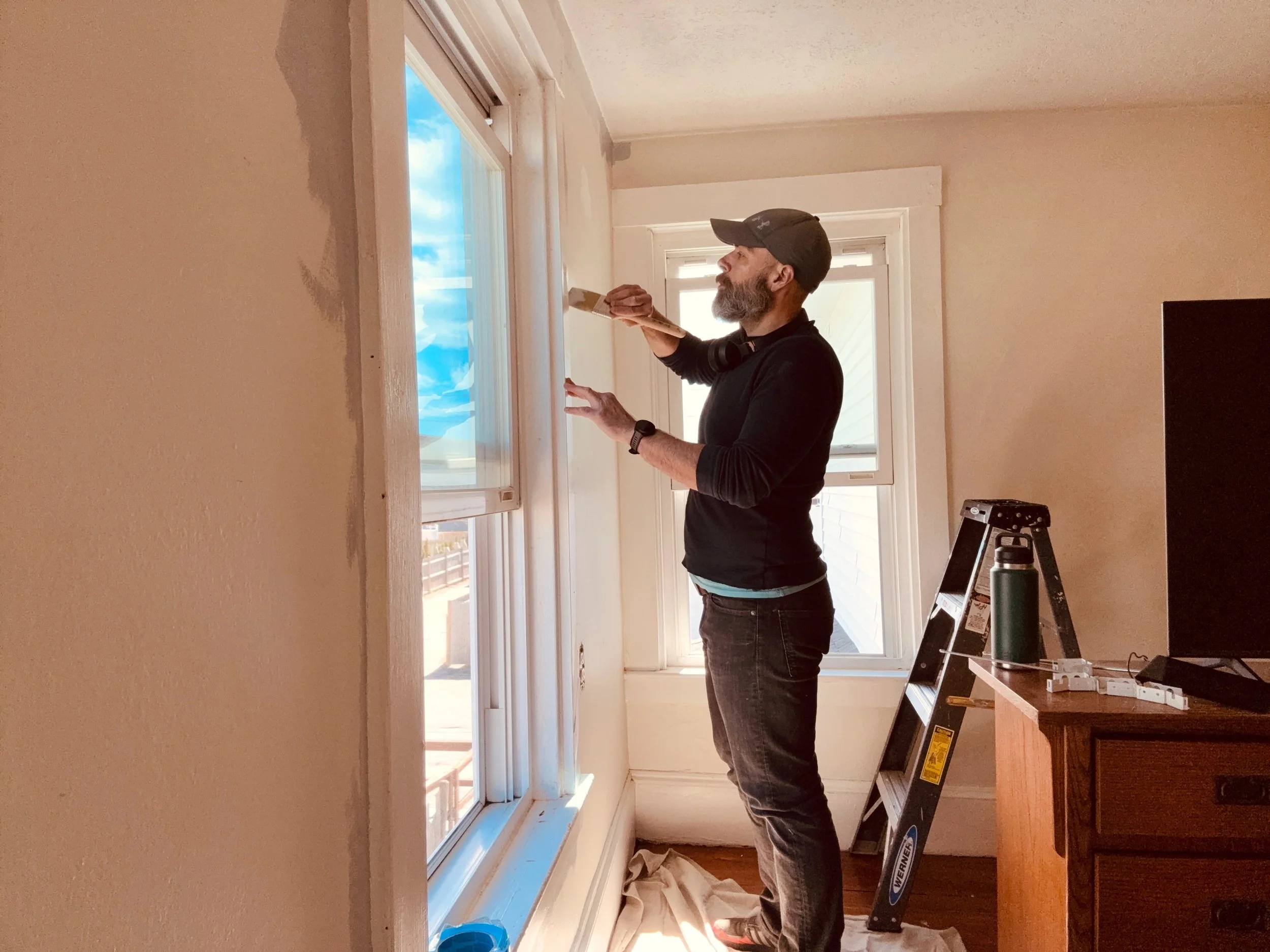 Water Works owner, Jay Woodward, painting the interior of a home in Hull, MA