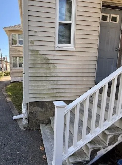 Before: Vinyl siding and stairs in Quincy, MA with visible dirt and grime buildup.