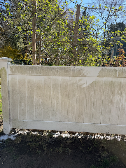 Before: Vinyl fence with visible dirt, algae, and weather-related buildup before professional pressure washing in Randolf, MA.
