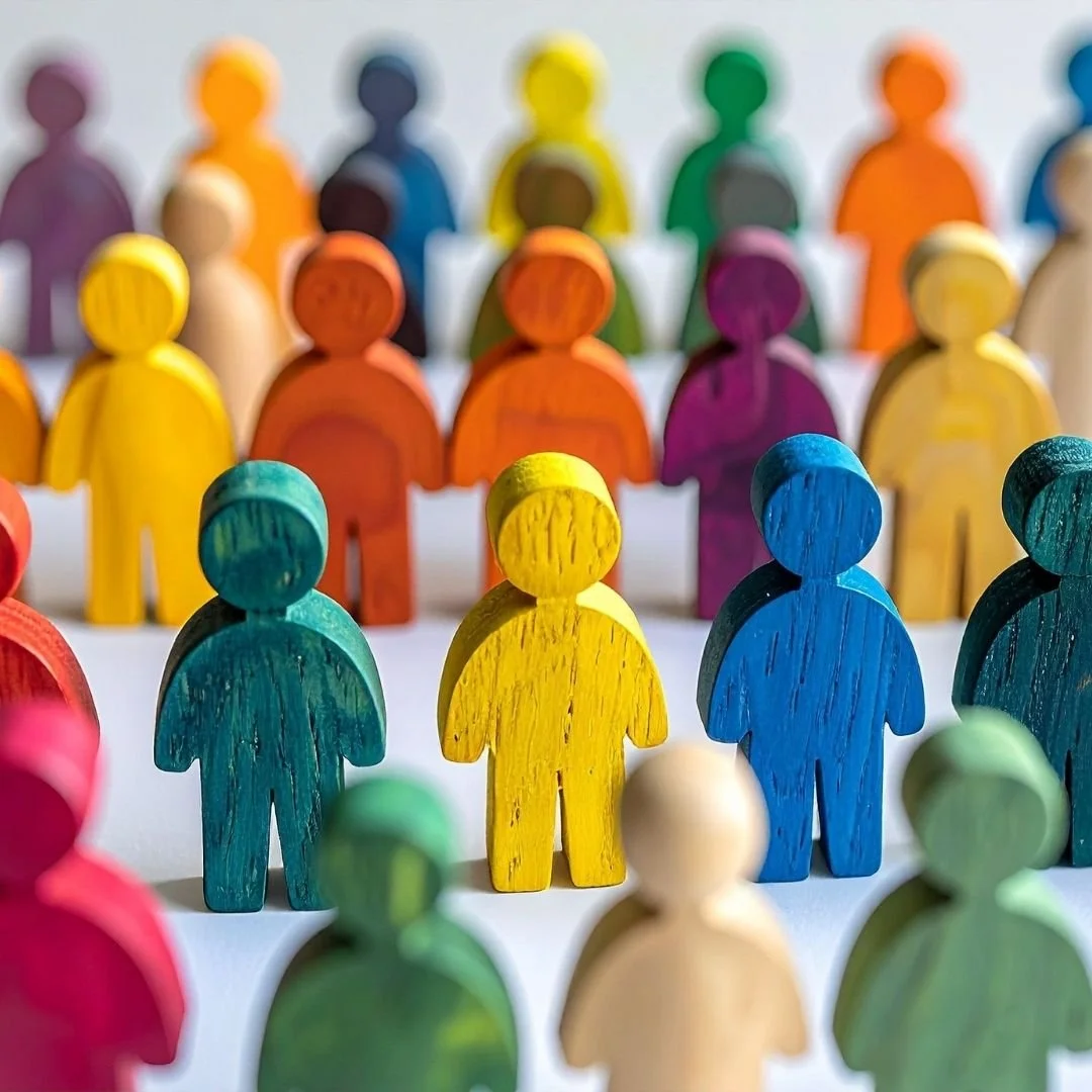 Colored wooden human figurines arranged in rows, representing Equity, Diversity, Inclusion and Belonging.