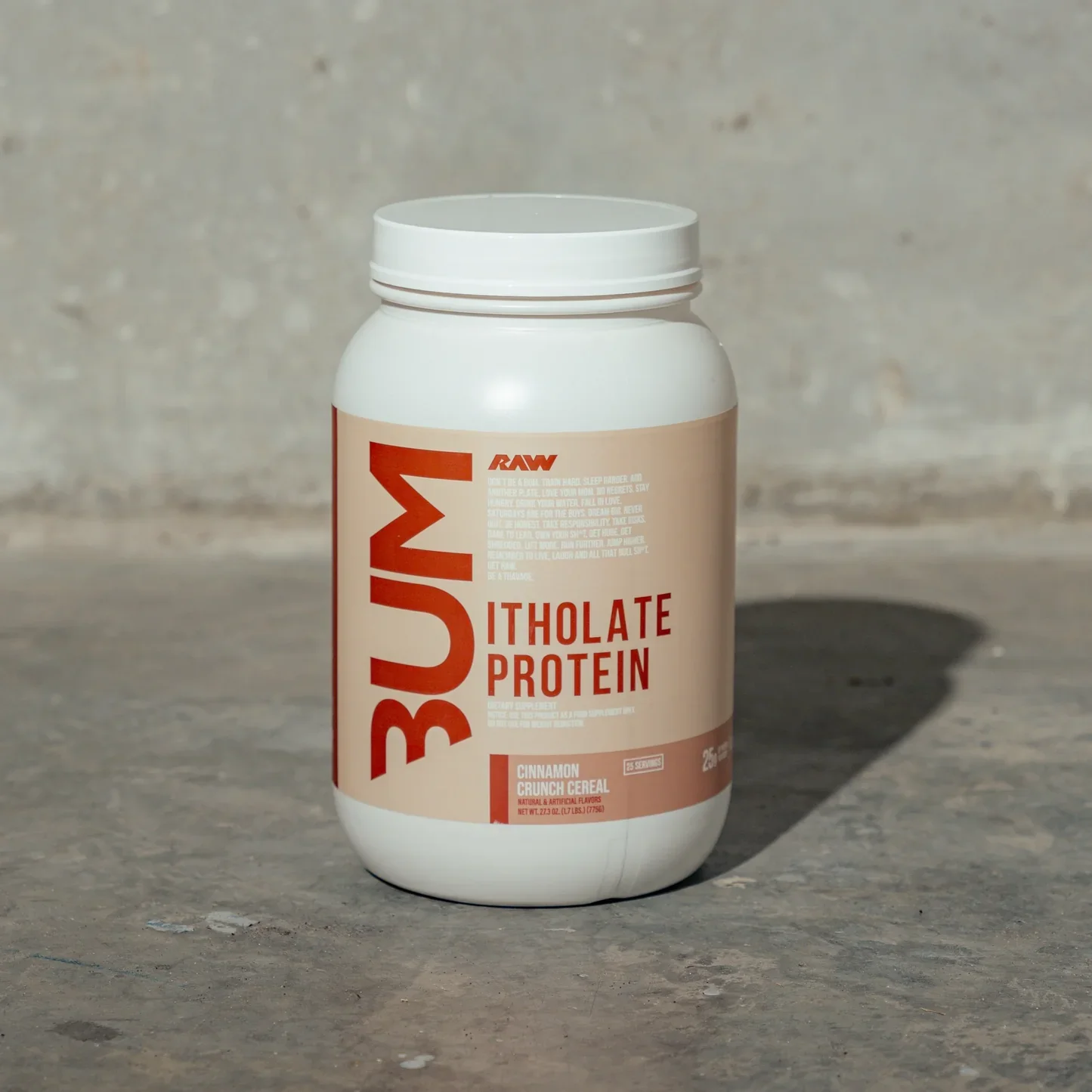 A white container of BUM Big Mushroom Itholate Protein supplement with cinnamon crunch cereal flavor placed on a concrete surface, casting a shadow to the right.