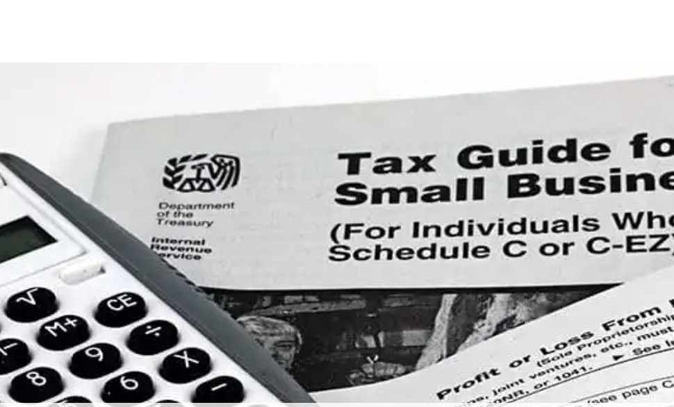 A calculator and a tax guide for small businesses