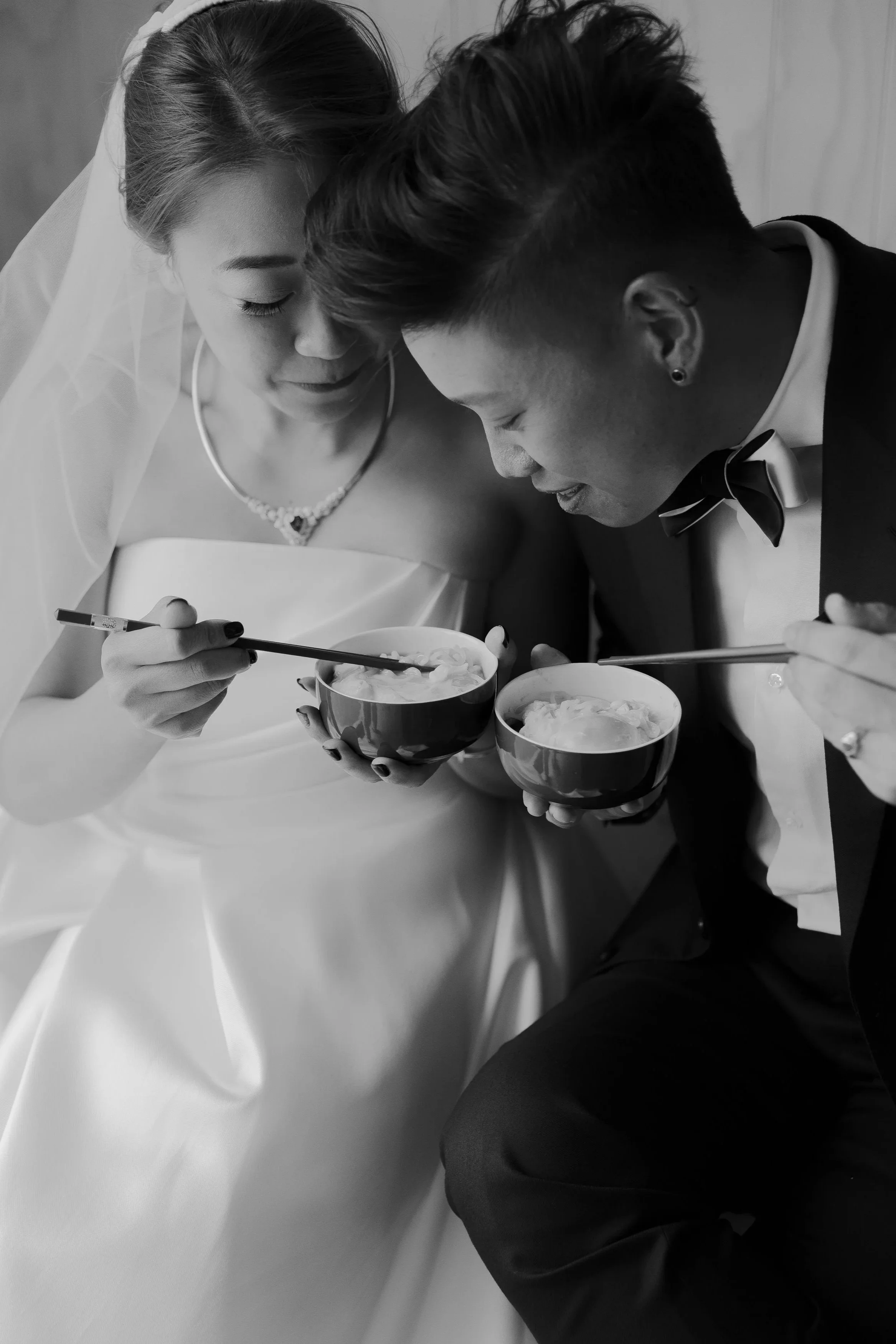 Bride and groom eating noodles