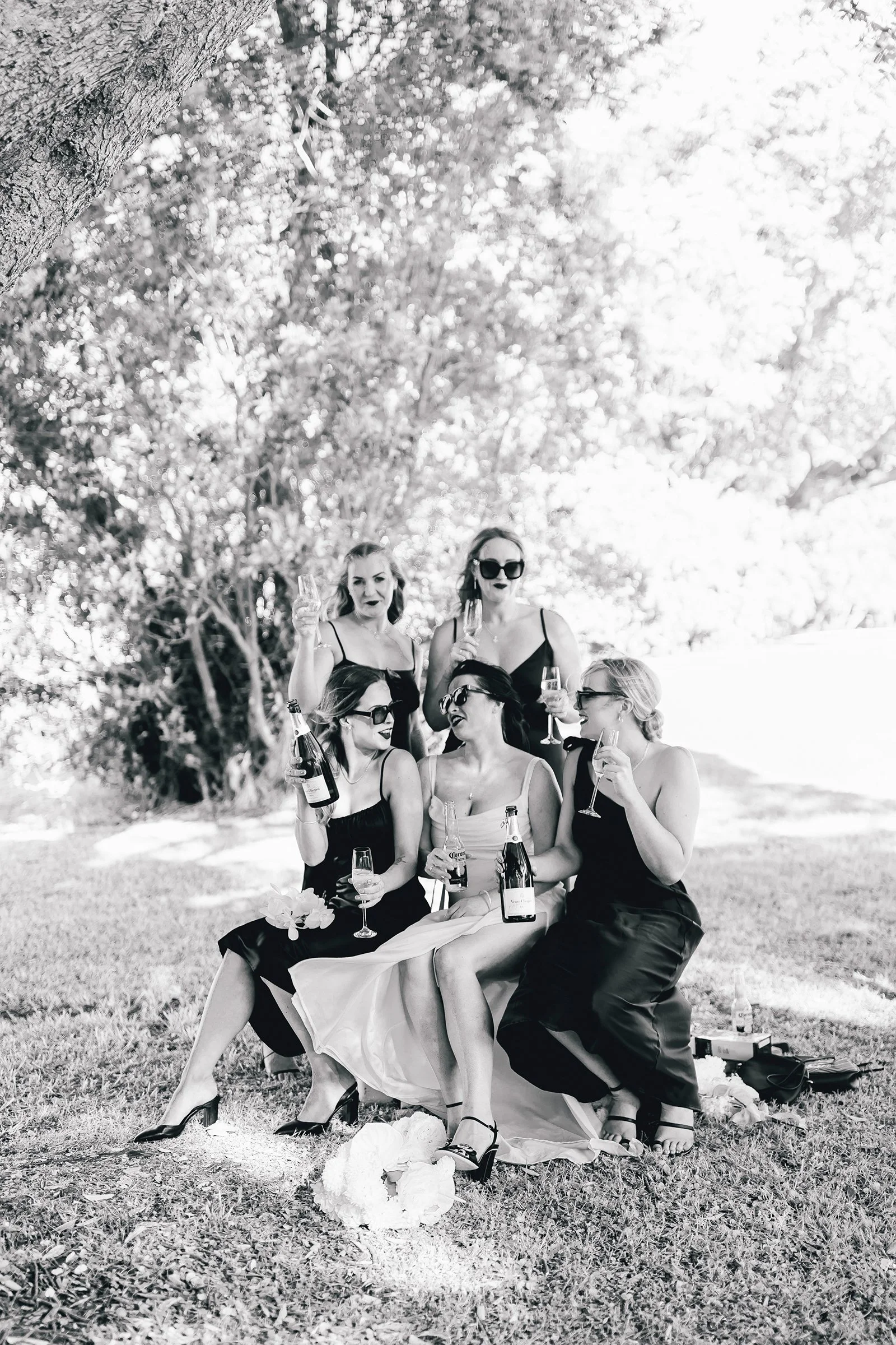 Bride and bridesmaids drinking champagne