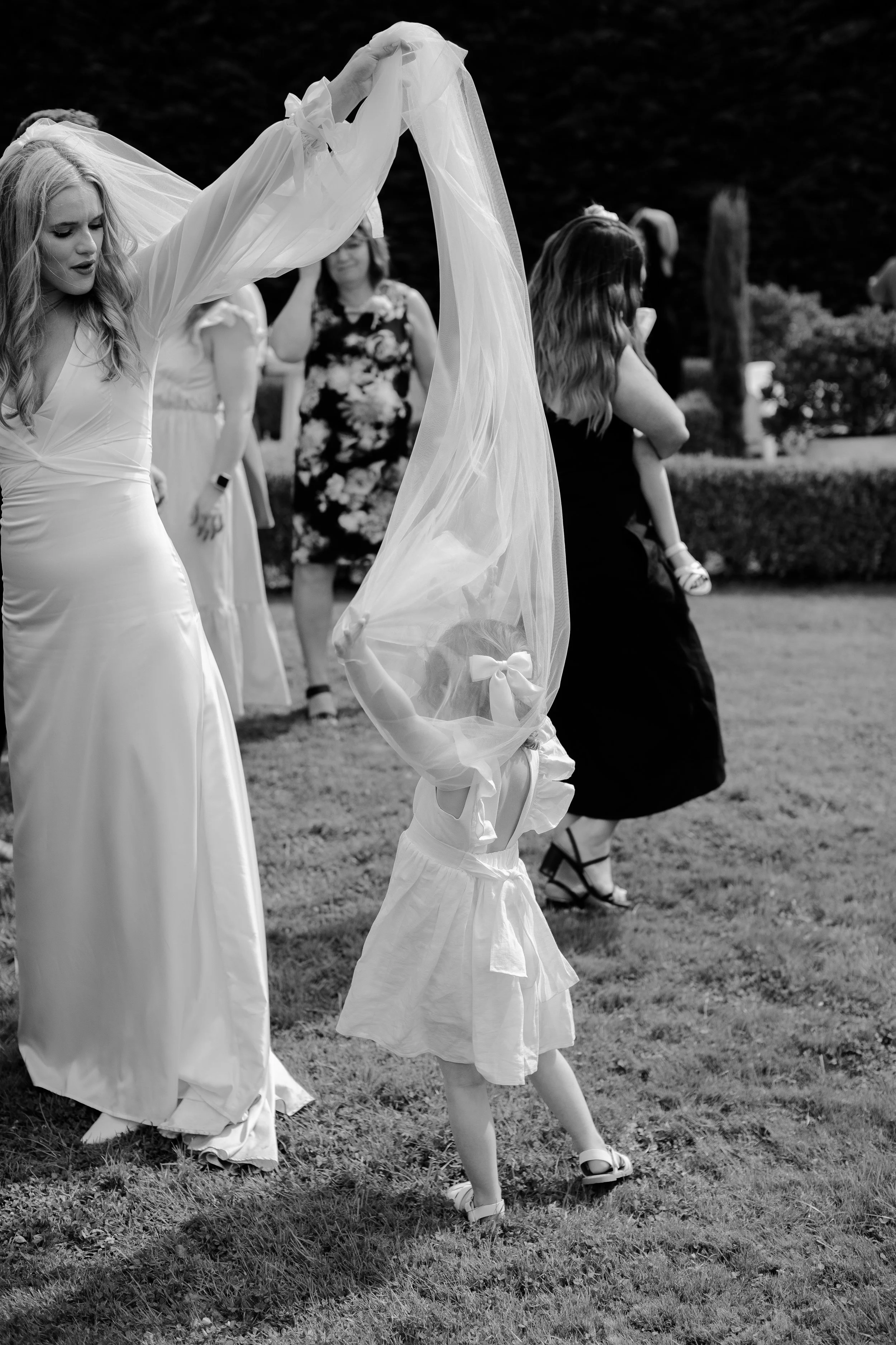 Child paying in brides veil