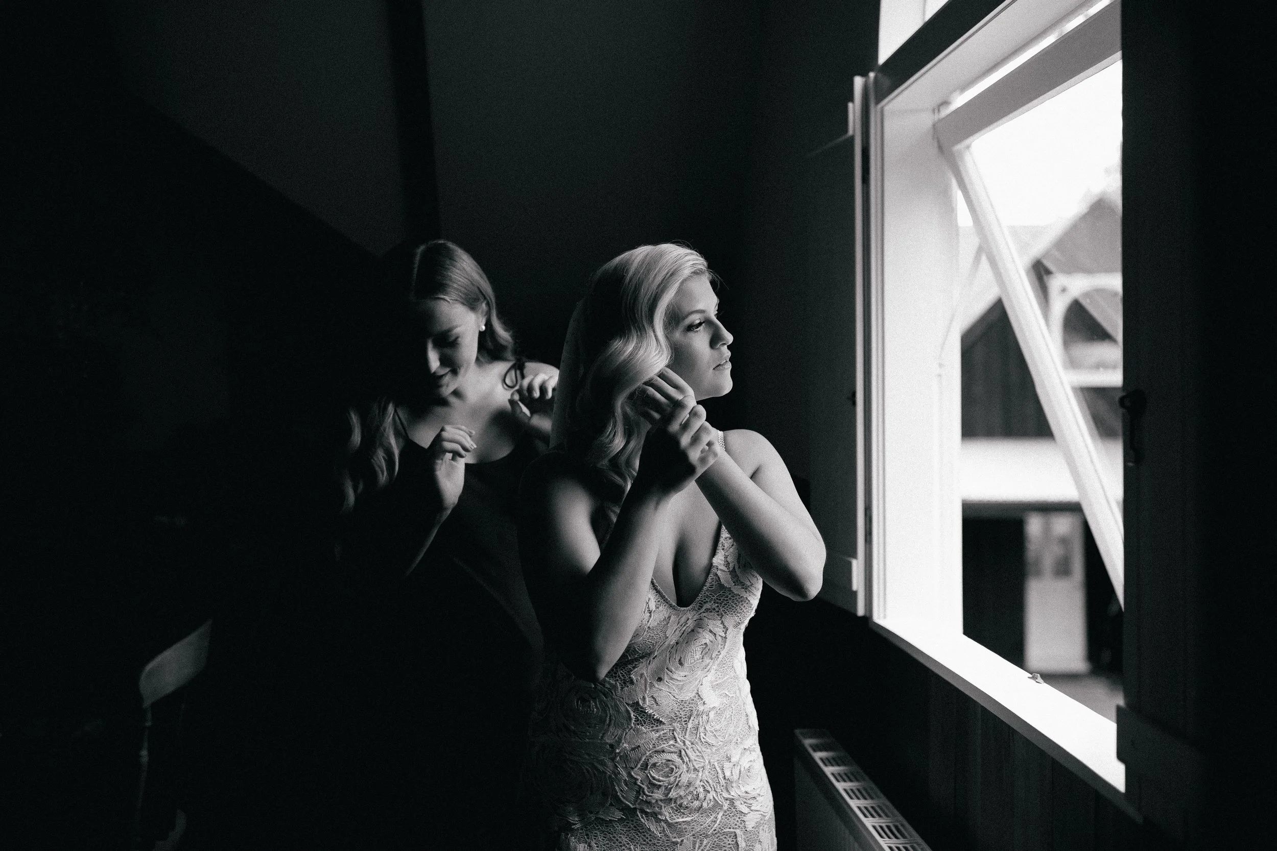 Bridesmaid helping bride get ready