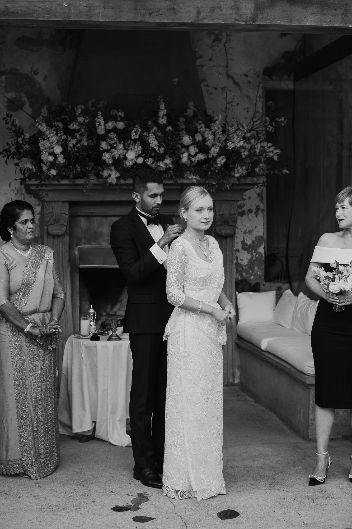 Placing a necklace on the bride