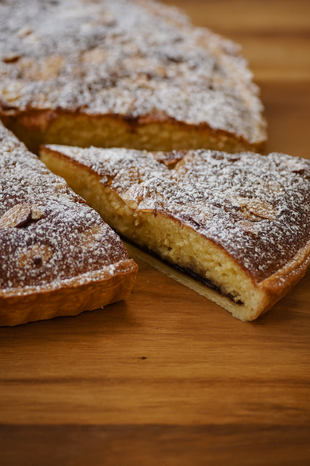 Bakewell Tart on a board - sliced and ready to eat