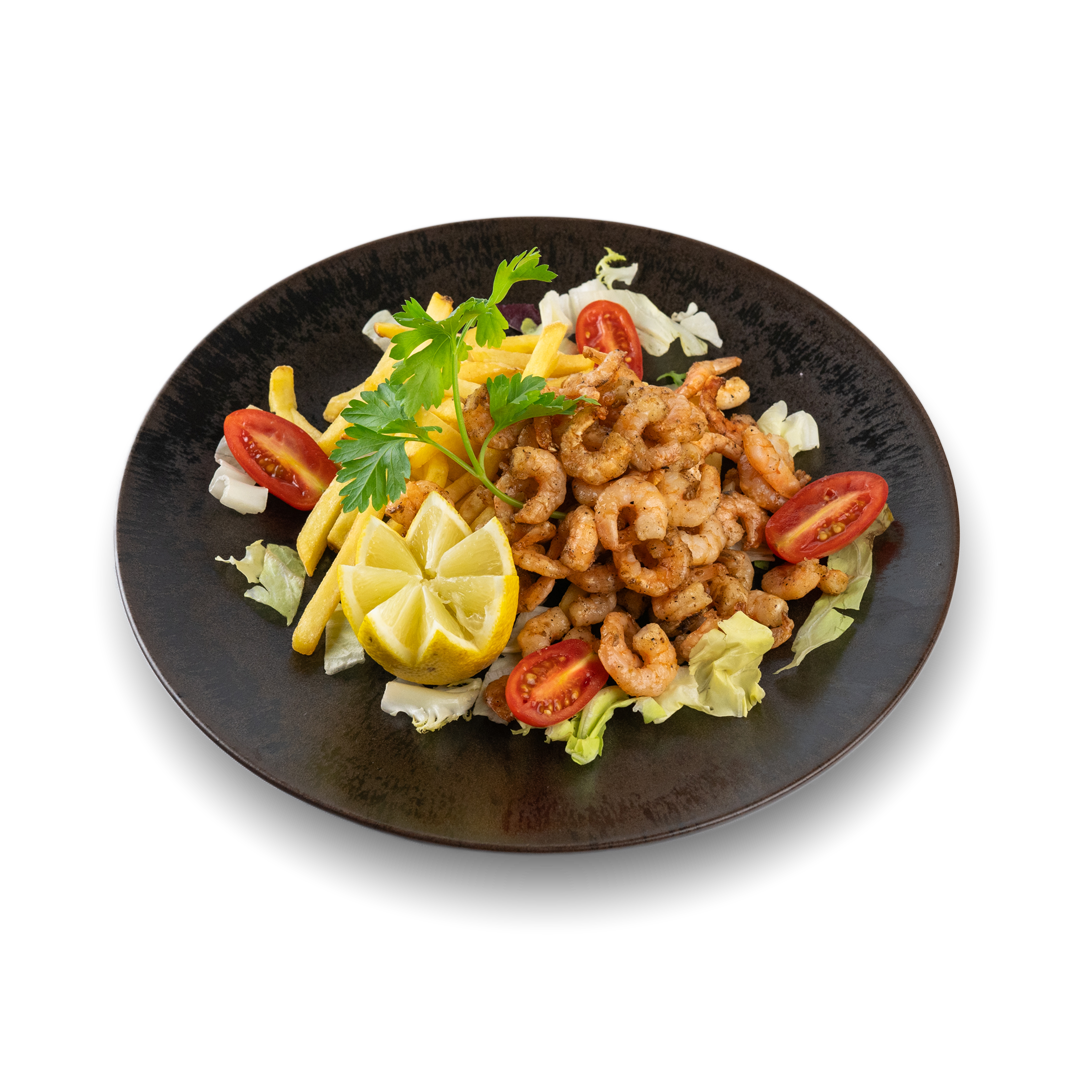 Salat mit gehackten Garnelen, Kirschtomaten, Zitronenscheiben, Paprikastreifen und Kräutern auf einem schwarzen Teller