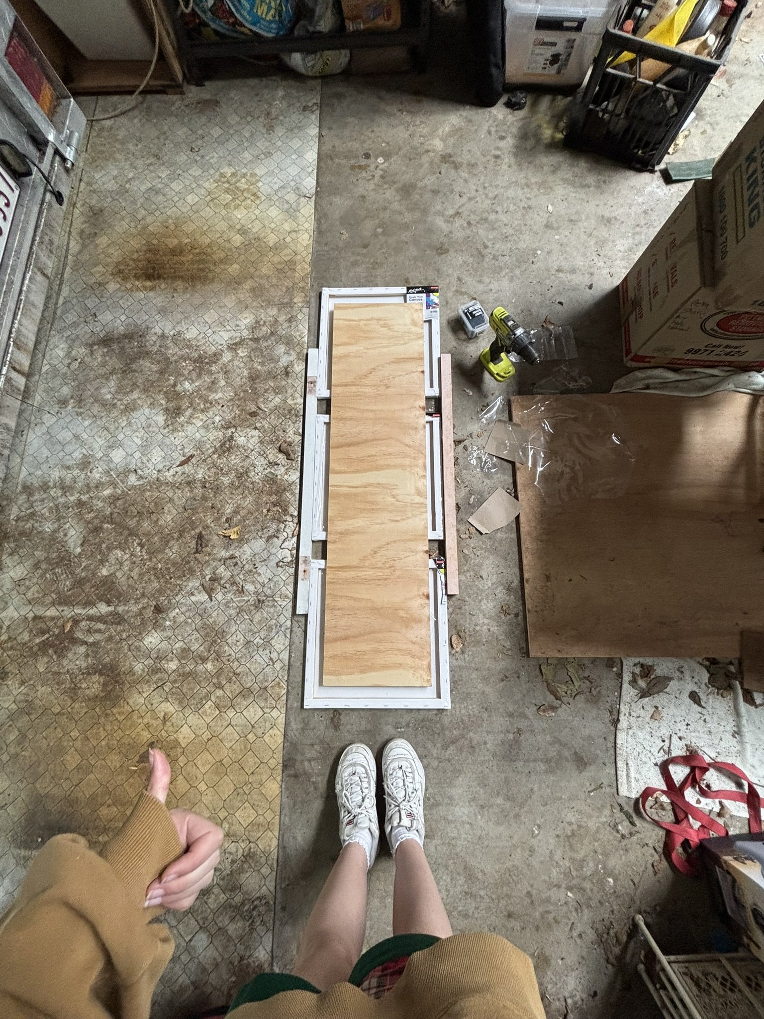 Screwing my canvases to a wooden board to keep them evenly spaced while I paint.