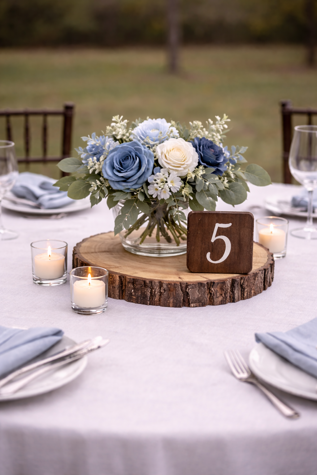 classic blue center piece, table numbers, real flowers.png