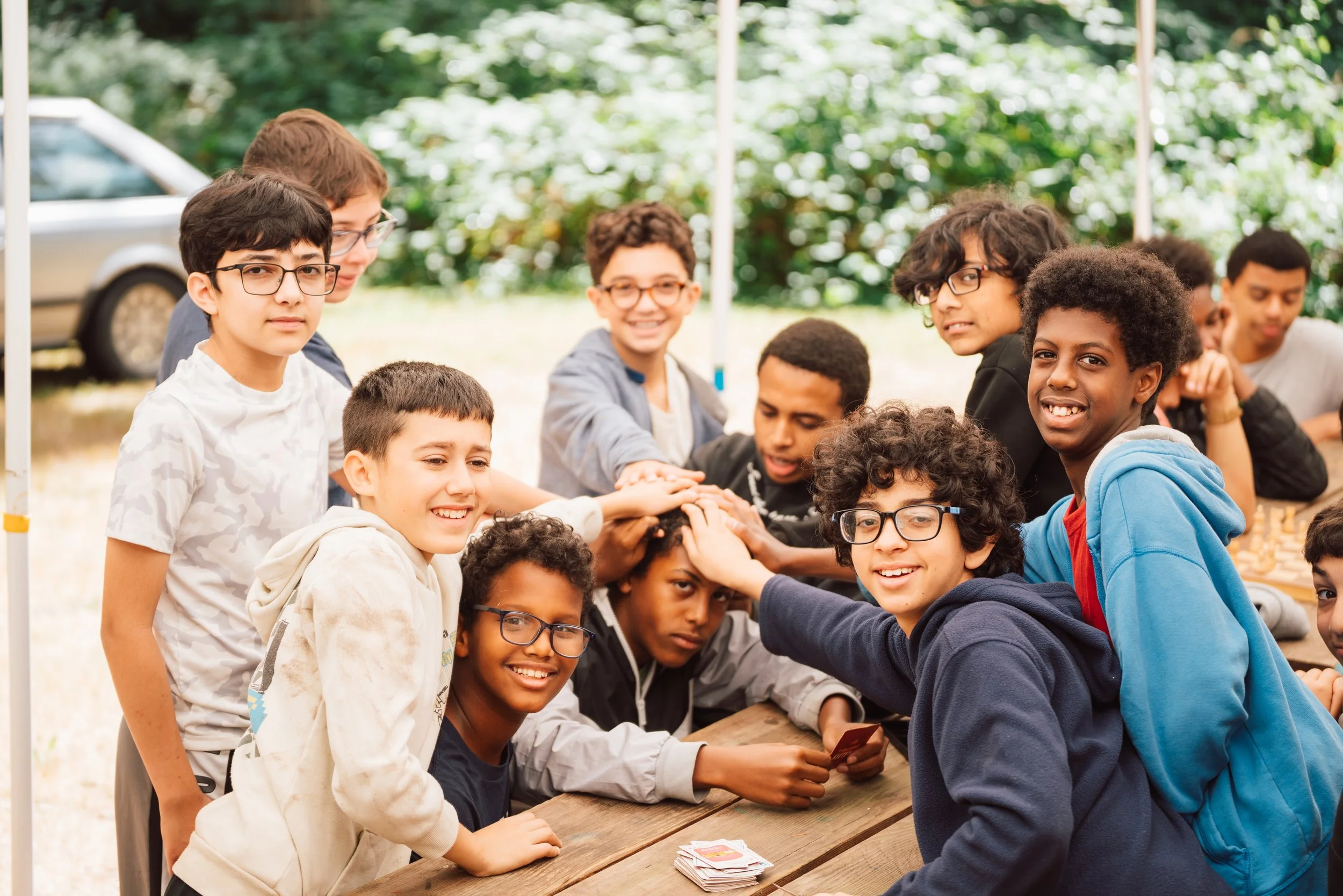 A group of youth huddling around each other at Camp Manara for the 