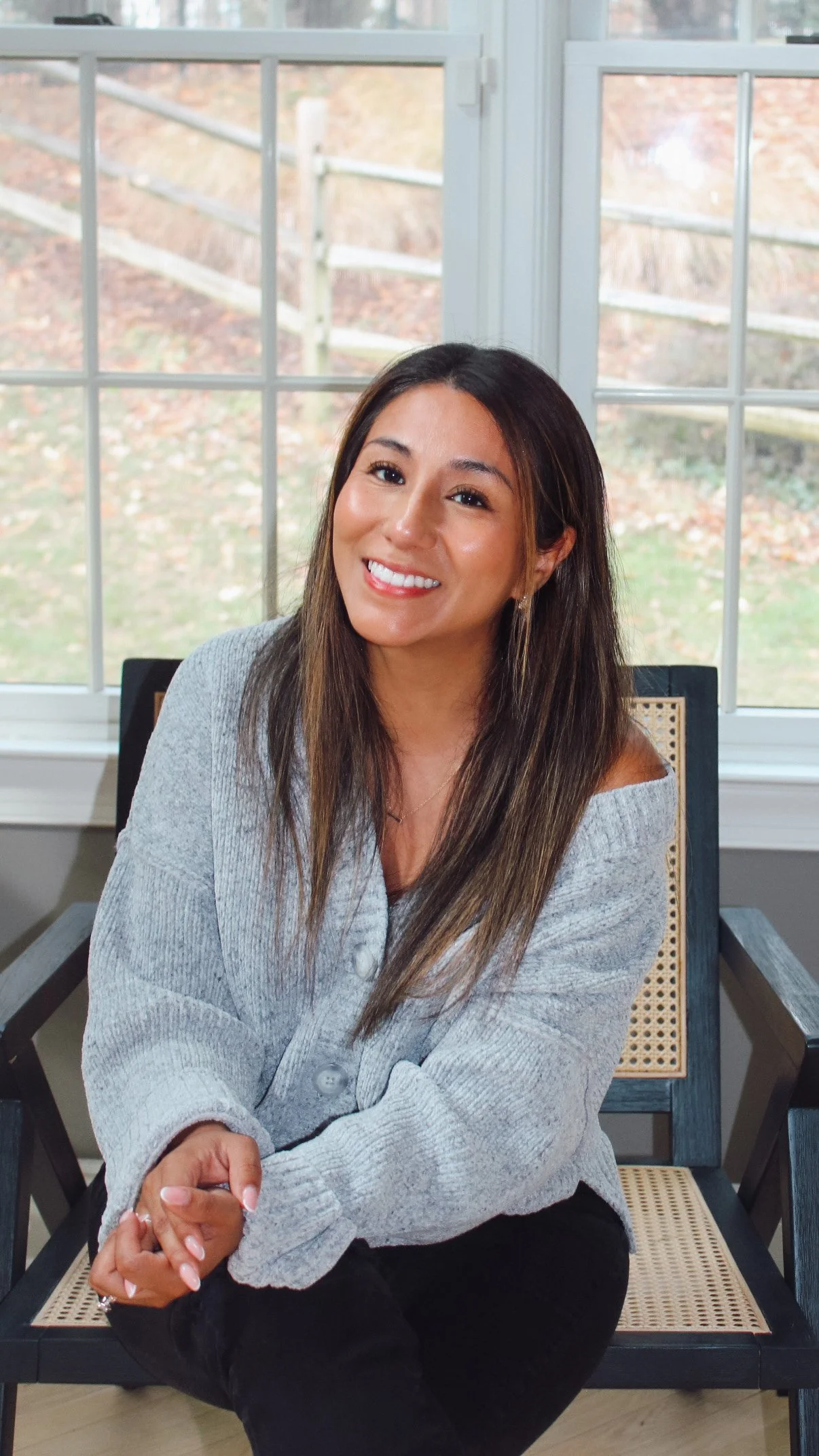 Portrait of Vicky Gorman, creative designer, seated in a cozy, natural-light setting.