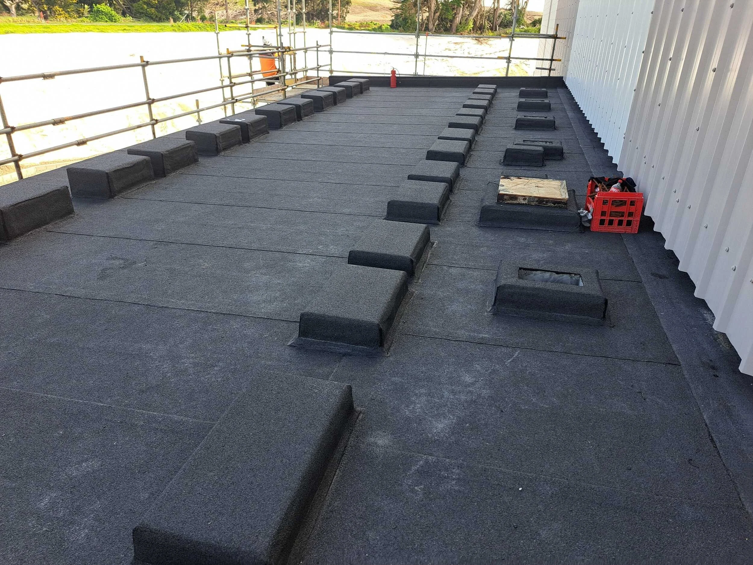 Flat roof membrane system with insulation boards, commercial building Auckland