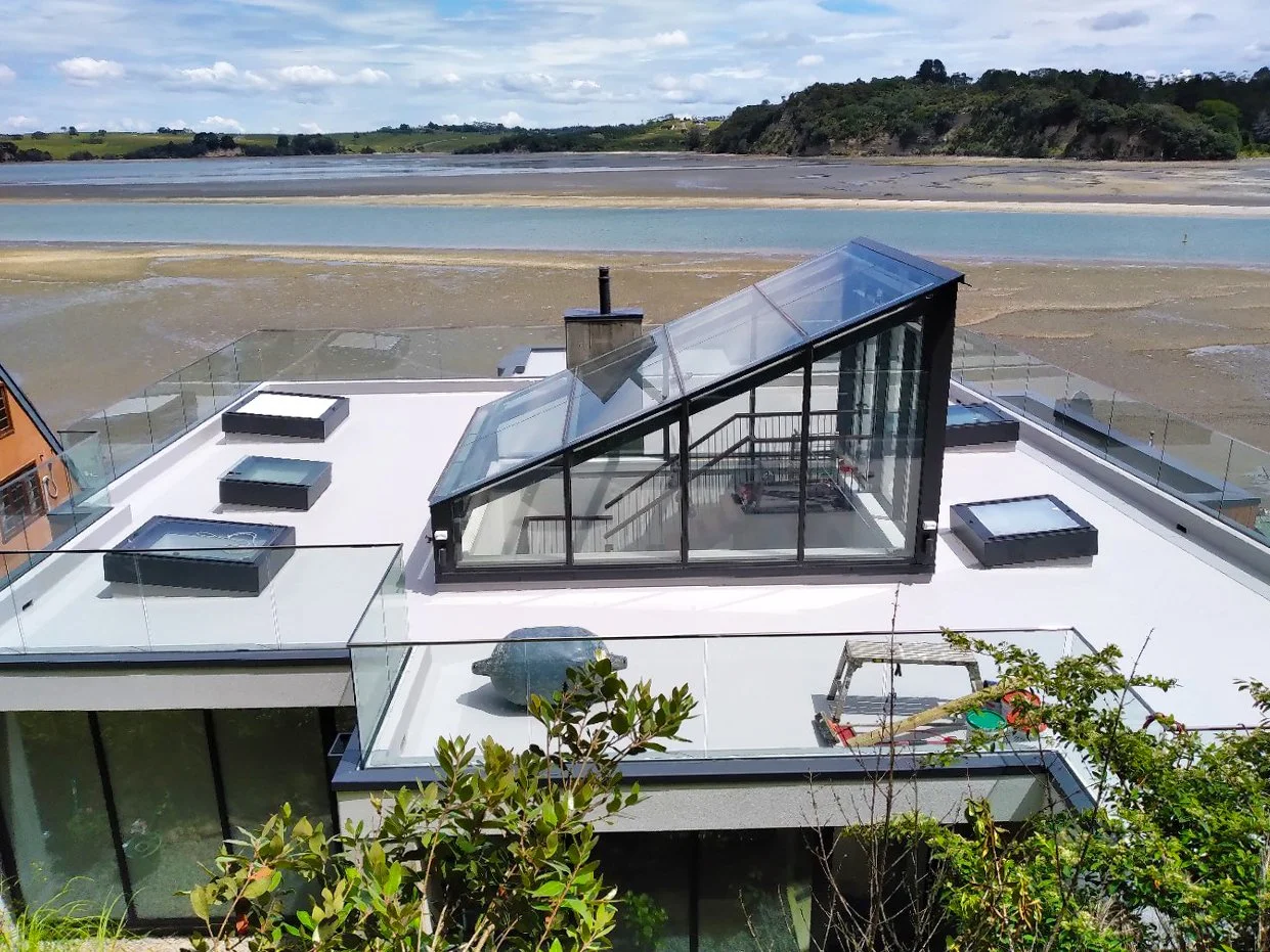 Joint sealing applied to glazed facade and roof deck on coastal residential property, Auckland