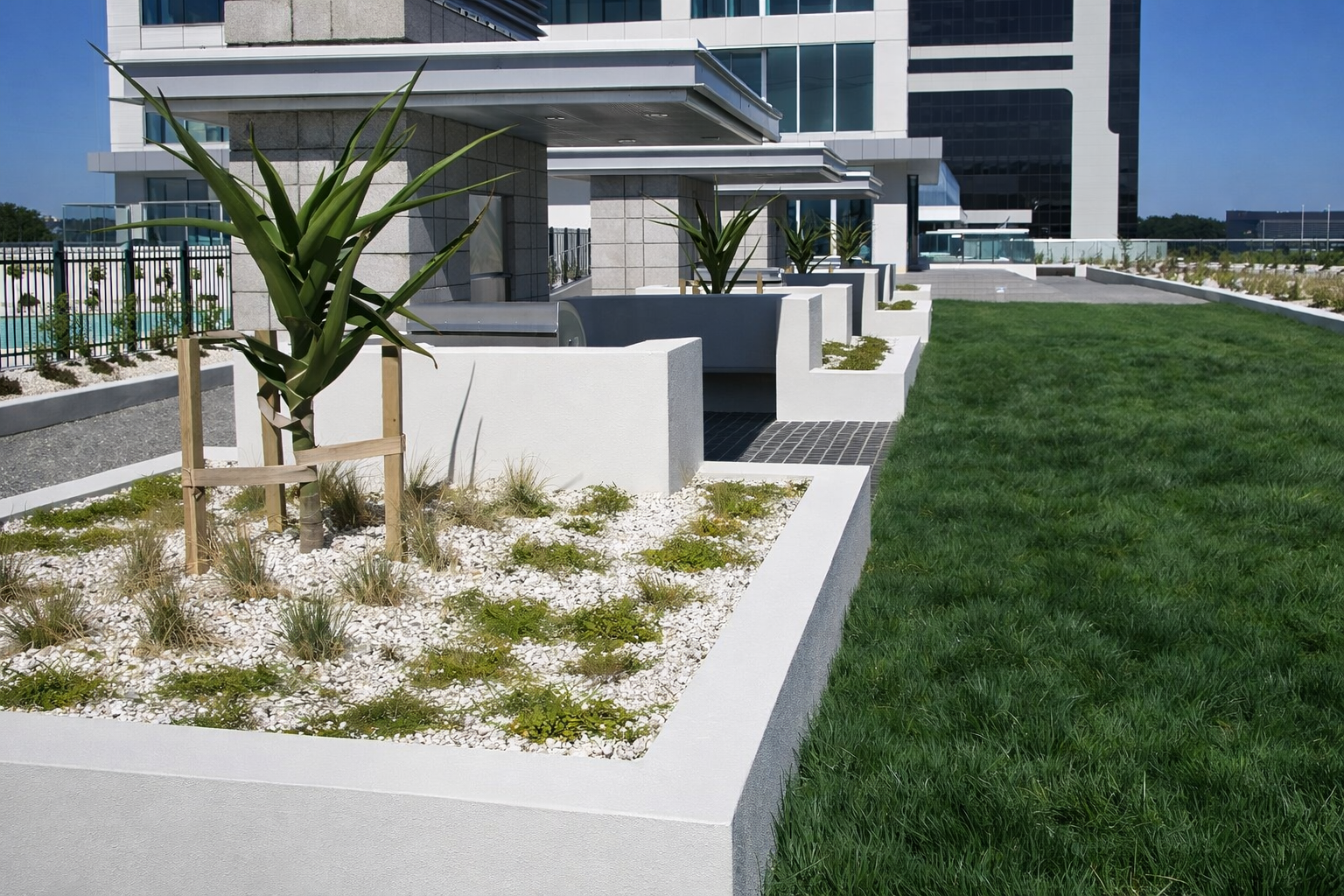 Landscaped commercial podium with green roof areas and waterproofed concrete surrounds, Auckland