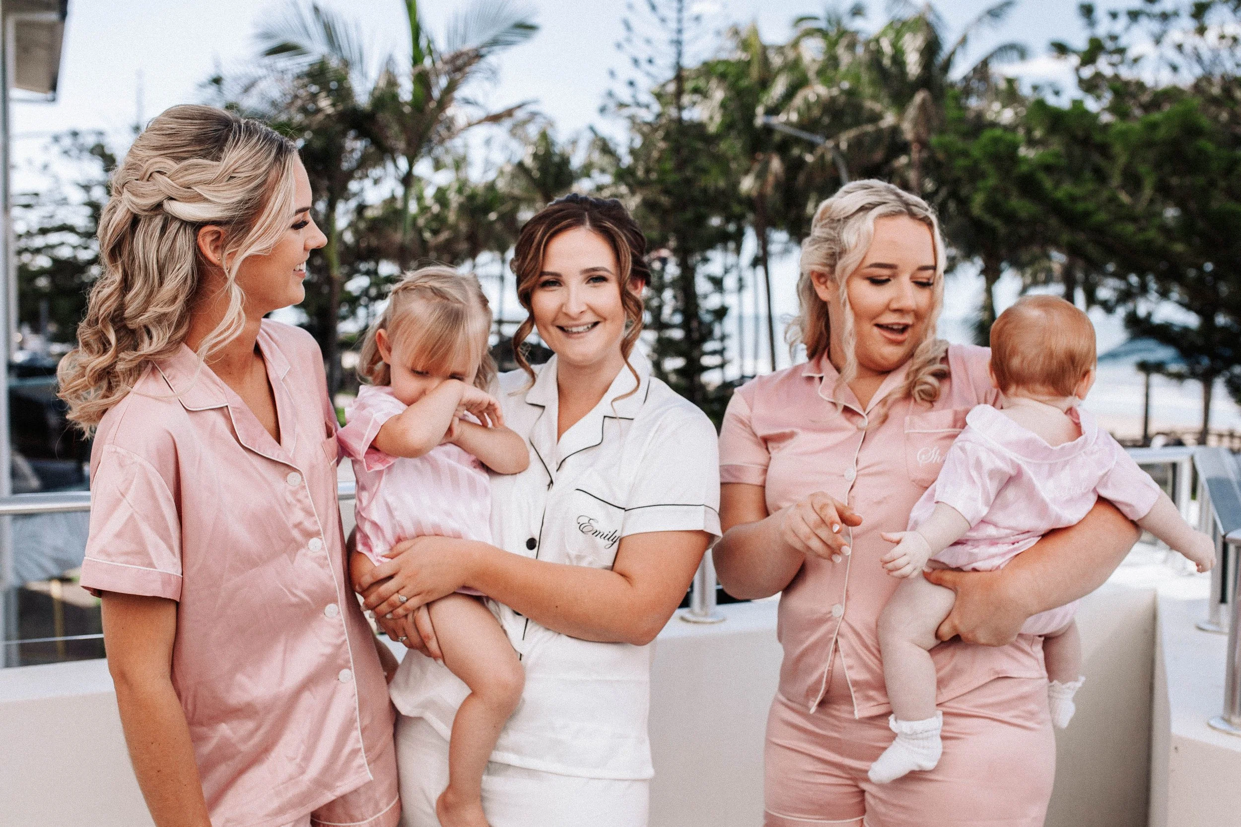 Bride poses with bridesmaids and nieces during prep in Yeppoon