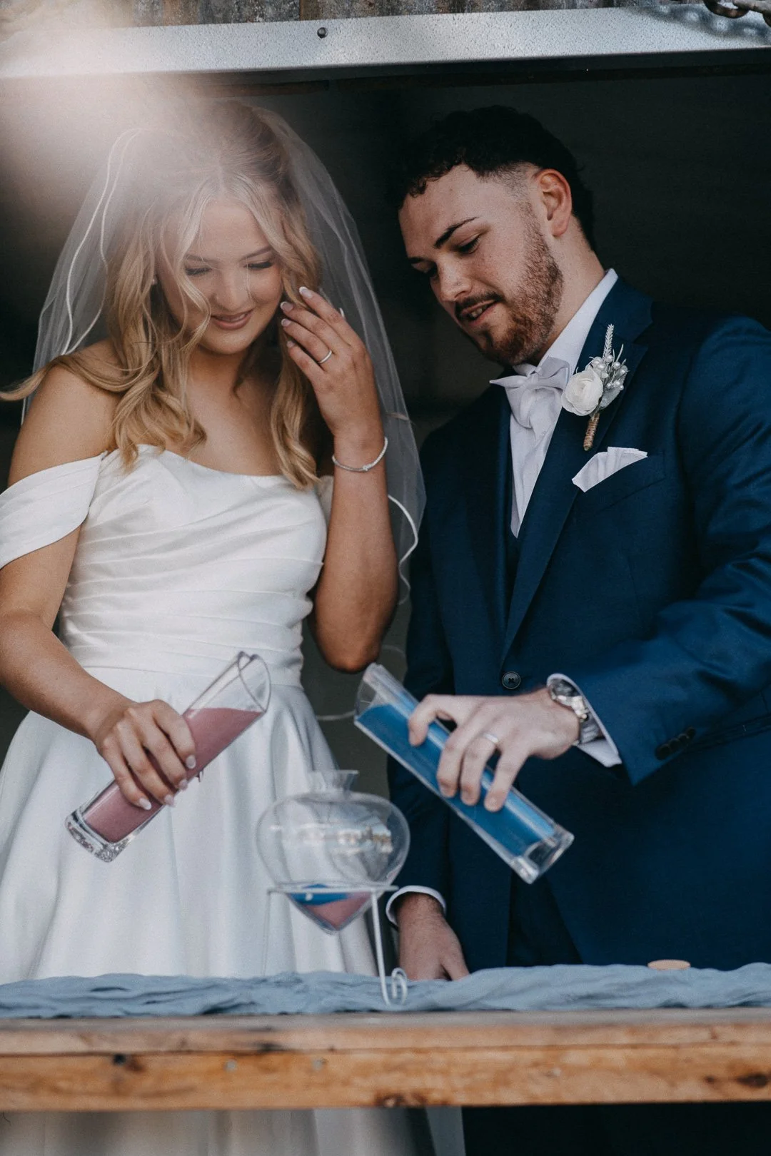 Bride and groom perform sand ceremony at country wedding near Brisbane