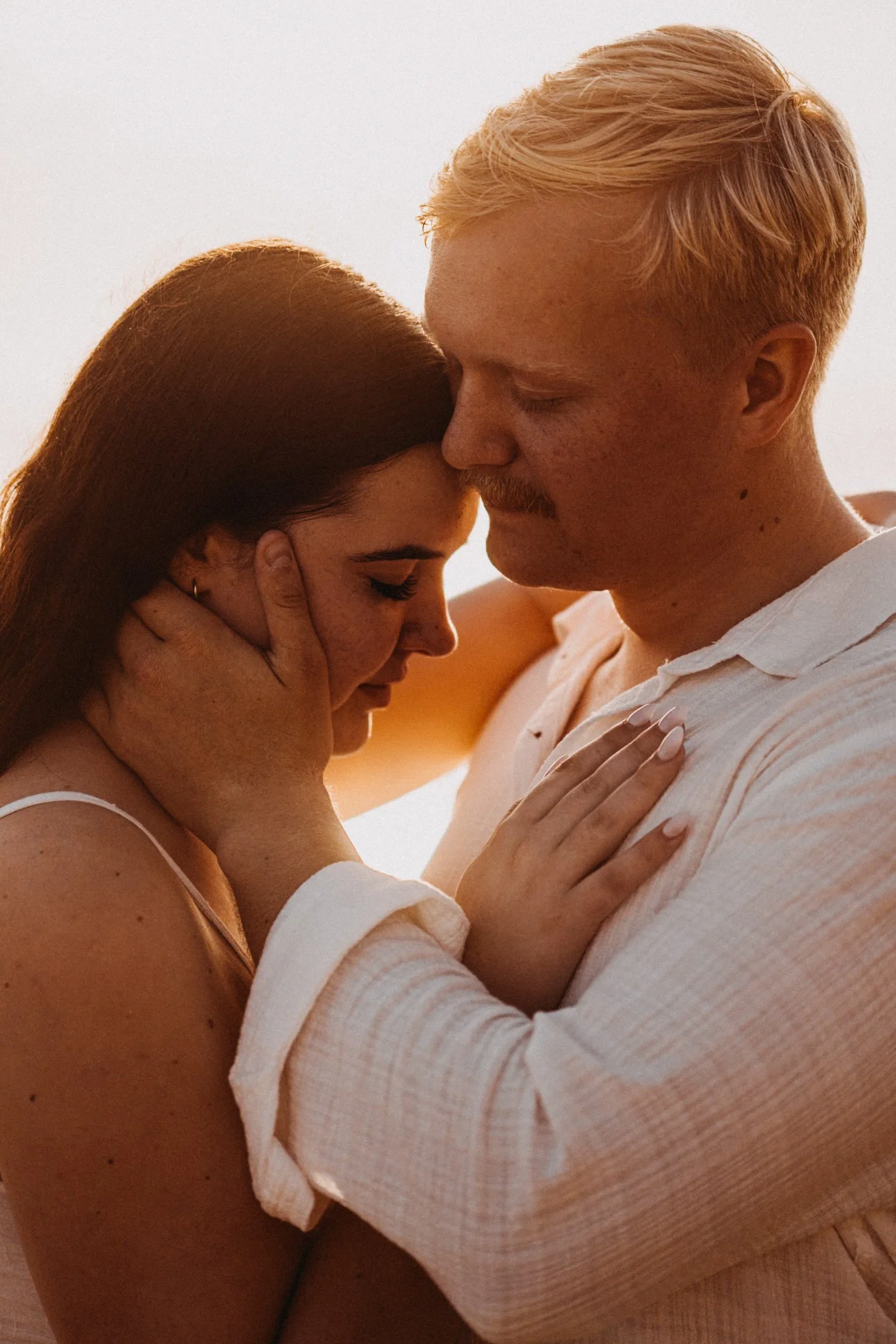 Couple holding each other during a sunrise elopement at Coolum Beach