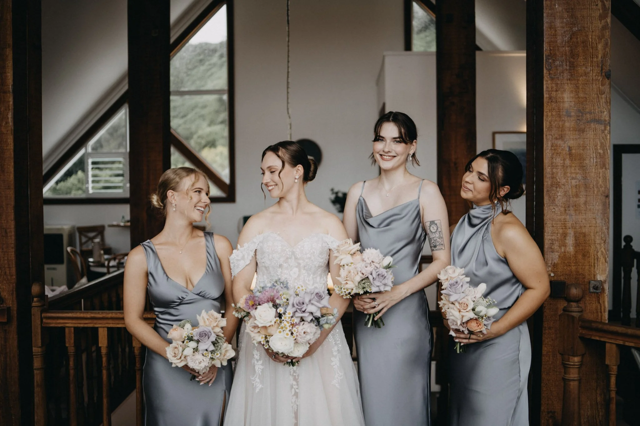 Bridal party poses with bouquets indoors in Maleny