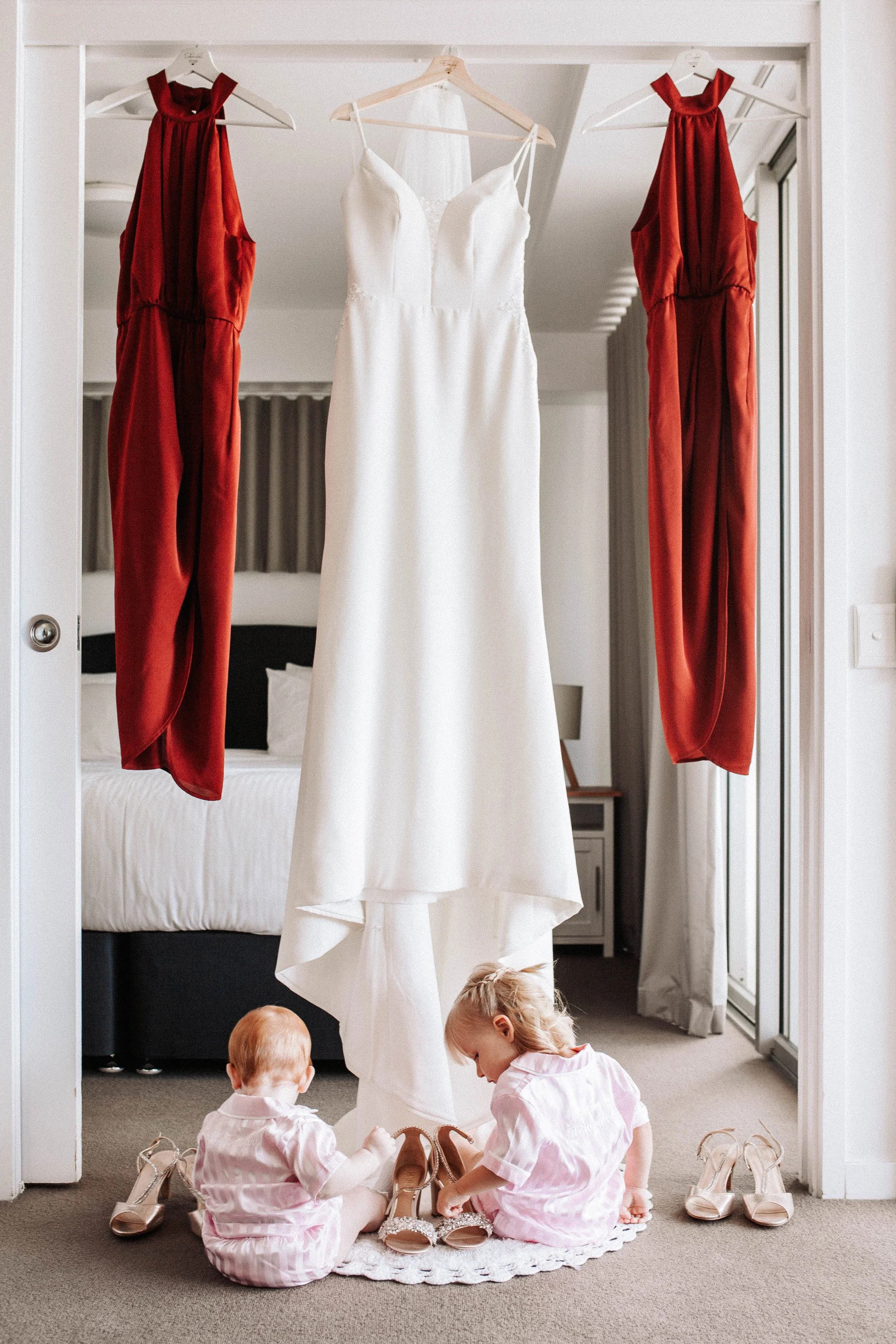 Babies pose with wedding dress and shoes at prep in Yeppoon