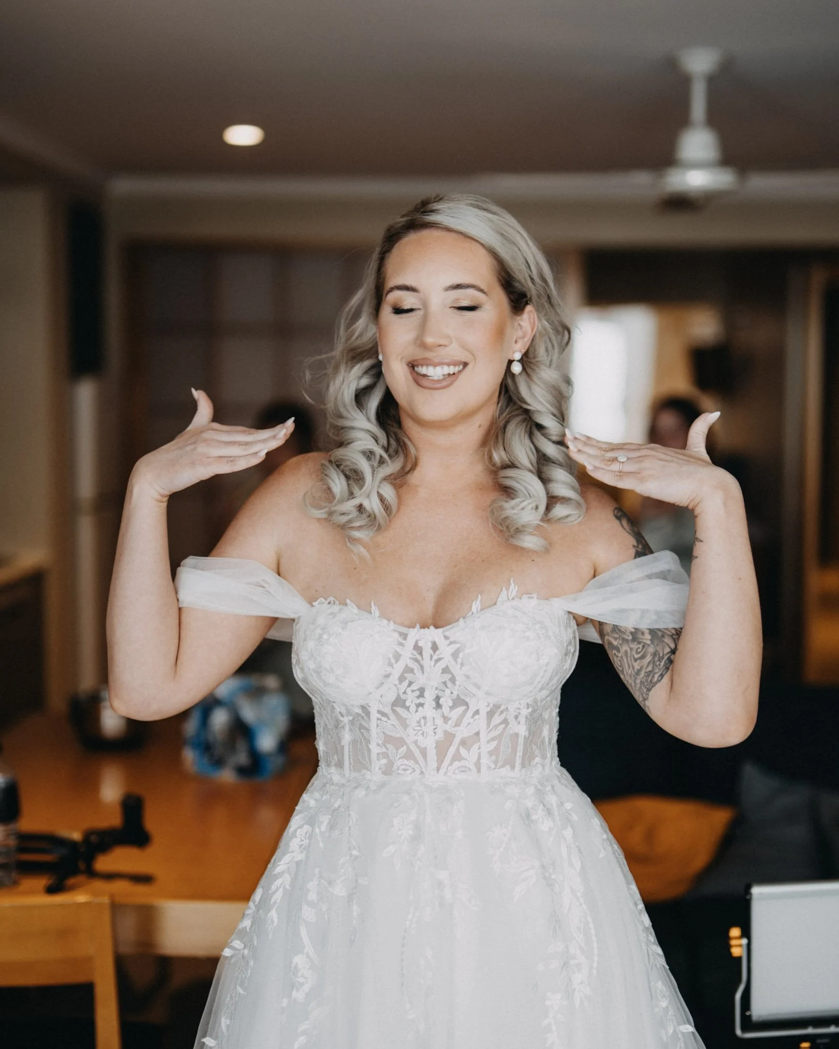 Bride fans herself after makeup at Hervey Bay wedding prep