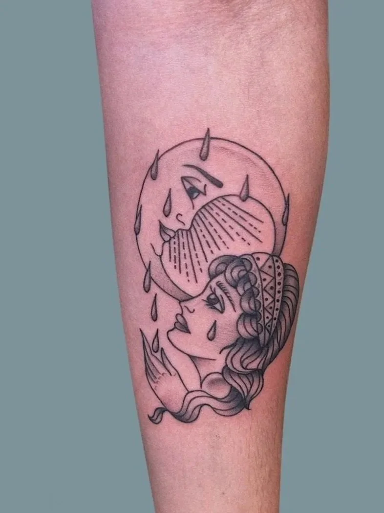 Tattoo of a woman with long hair, wearing a headband, looking up with tears falling, with a crying moon above her, also with tears.